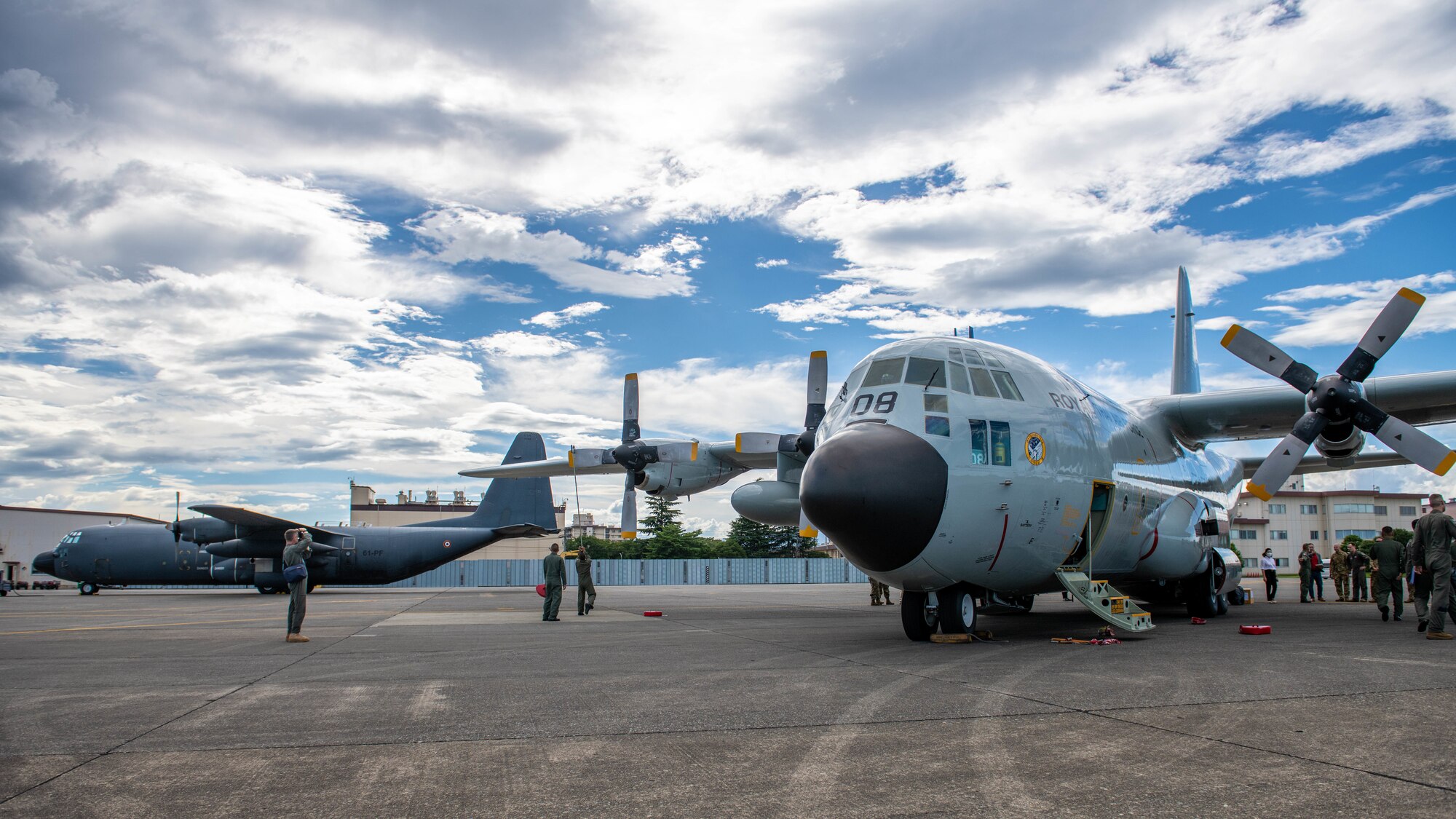 Two C-130H Hercules sit on a flightline