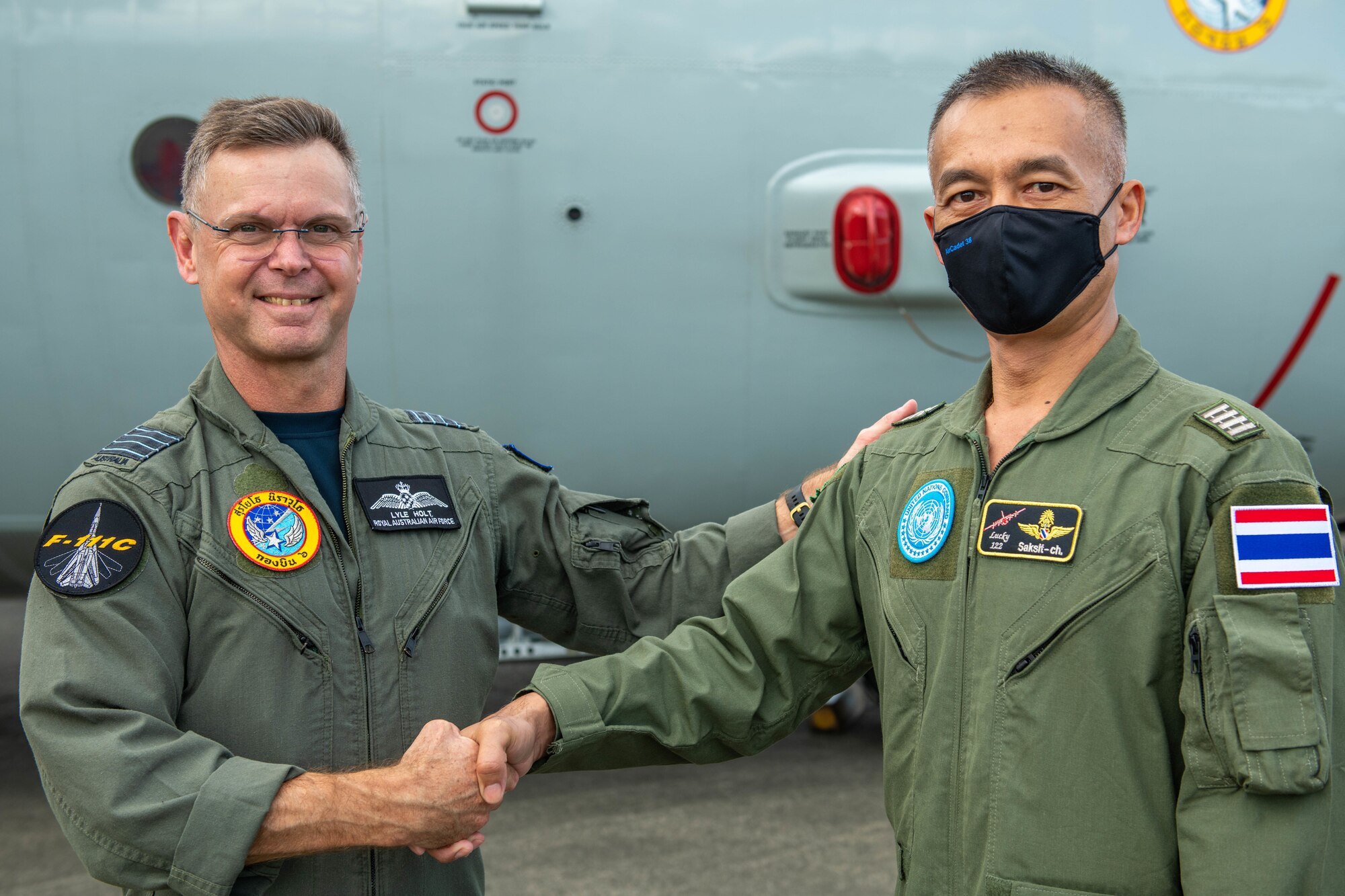 Representatives from UNC-R and RTAF shake hands