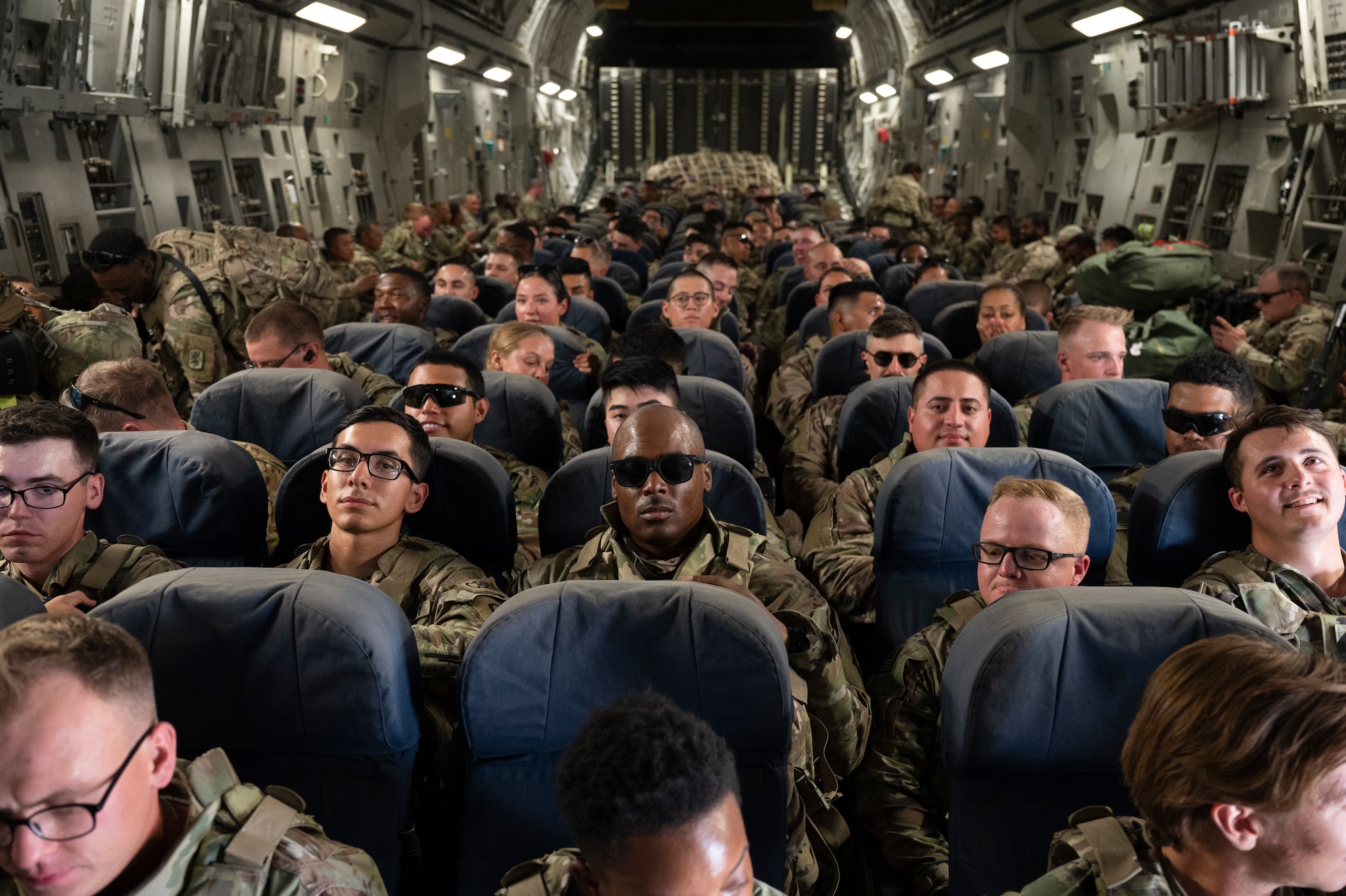 U.S. Army Task Force Griz Soldiers from the 1st Combined Arms Battalion, 163rd Cavalry Regiment, get ready for takeoff aboard a C-17 Globemaster III during an Emergency Deployment Rapid Exercise at Ali Al Salem Air Base, Kuwait, August 10, 2022. This exercise tested the Army and Air Force’s joint capability to put boots on the ground and support the warfighter as quickly as possible through rapid global mobility. (U.S. Air Force photo by Staff Sgt. Dalton Williams)