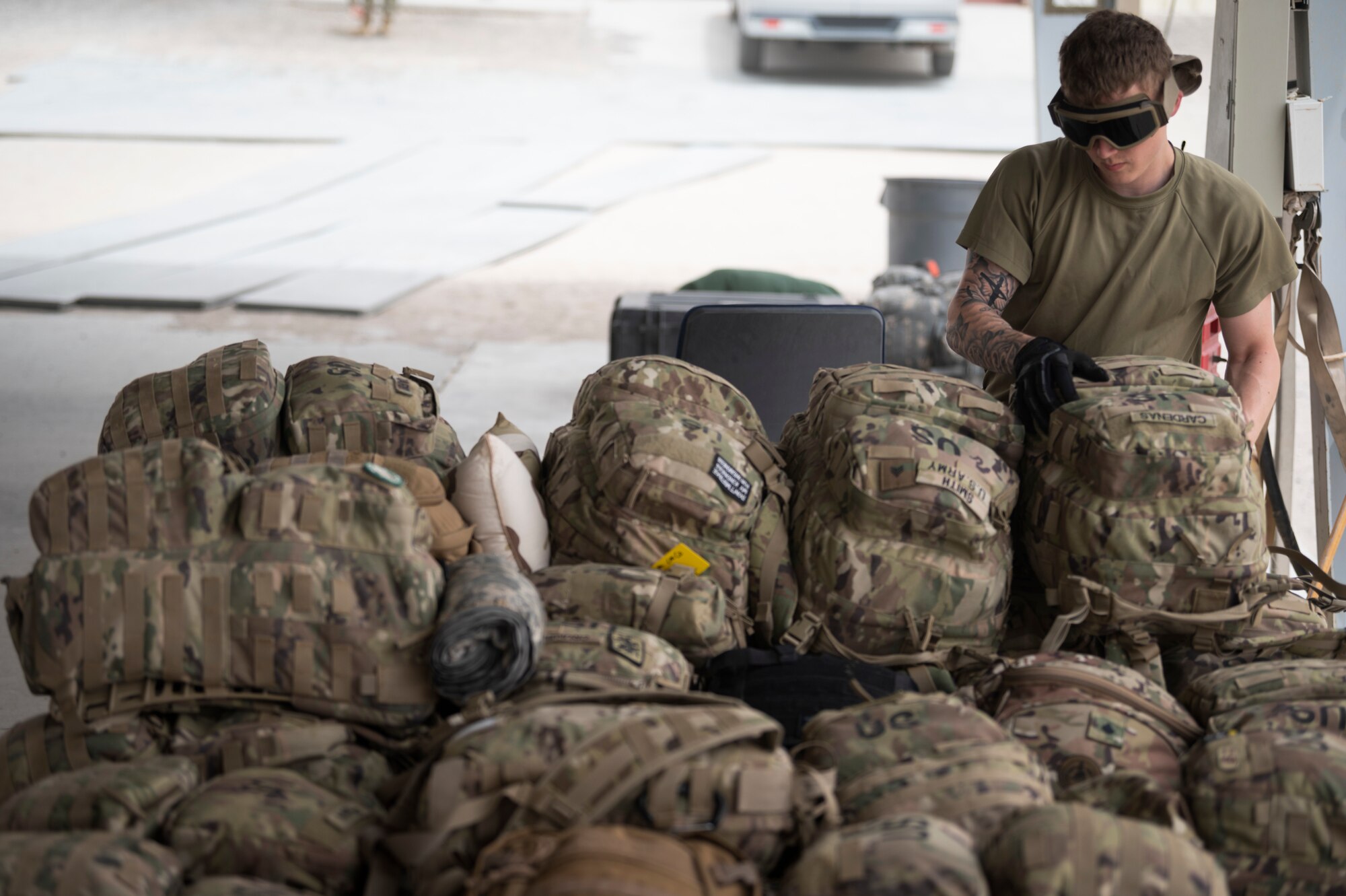 U.S. Air Force Senior Airman Clayton Ford, 386th Expeditionary Logistics Readiness Squadron passenger service representative, assembles a luggage pallet during an Emergency Deployment Rapid Exercise at the 386th ELRS passenger terminal at Ali Al Salem Air Base, Kuwait, August 10, 2022. In order for the team to ensure rapid mobility exercises like this are a success, every member of the team needs to be well trained at each part of the process, even working multiple parts at the same time. (U.S. Air Force photo by Staff Sgt. Dalton Williams)