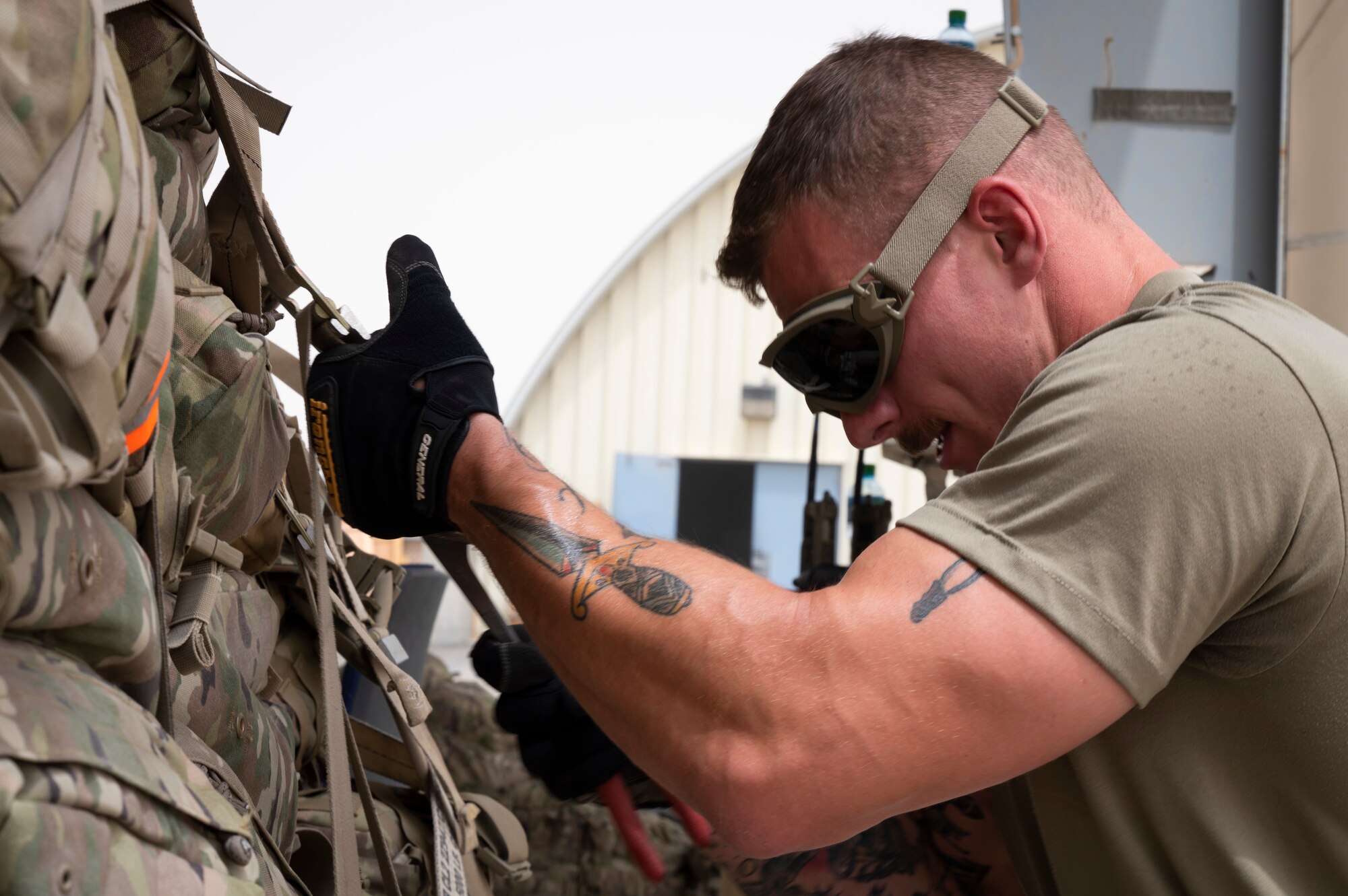 U.S. Air Force Staff Sgt. Franko Seper, 386th Expeditionary Logistics Readiness Squadron passenger services ground supervisor, tightens down the belly band straps on the side of a luggage pallet during an Emergency Deployment Rapid Exercise at the 386th ELRS passenger terminal at Ali Al Salem Air Base, Kuwait, August 10, 2022. Seper works with each Airmen ensuring mission success at every position for his multi-capable Airmen and that they are able to adapt to any scenario that the team faces. (U.S. Air Force photo by Staff Sgt. Dalton Williams)