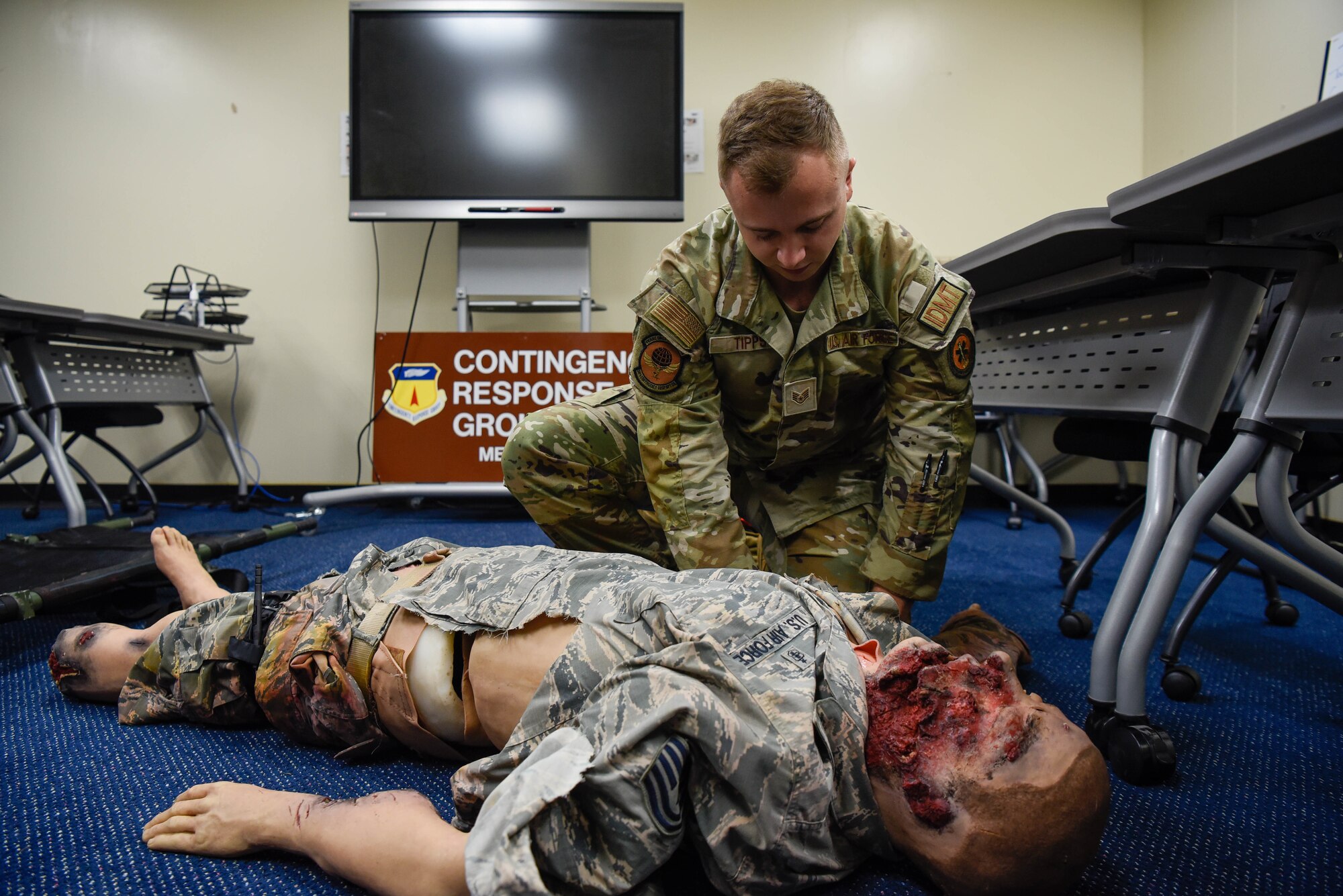 U.S. Air Force Staff Sgt. Finn Tipps, an independent duty medical technician assigned to the 36th Contingency Response Support Squadron, practices troop combat casualty care on a training mannequin on August 8, 2022, at Andersen Air Force Base, Guam. The skills Tipps has learned from the Air Force, allowed him to know how to provide care to a civilian in an off-base incident. (U.S. Air Force Photo by Airman 1st Class Allison Martin)