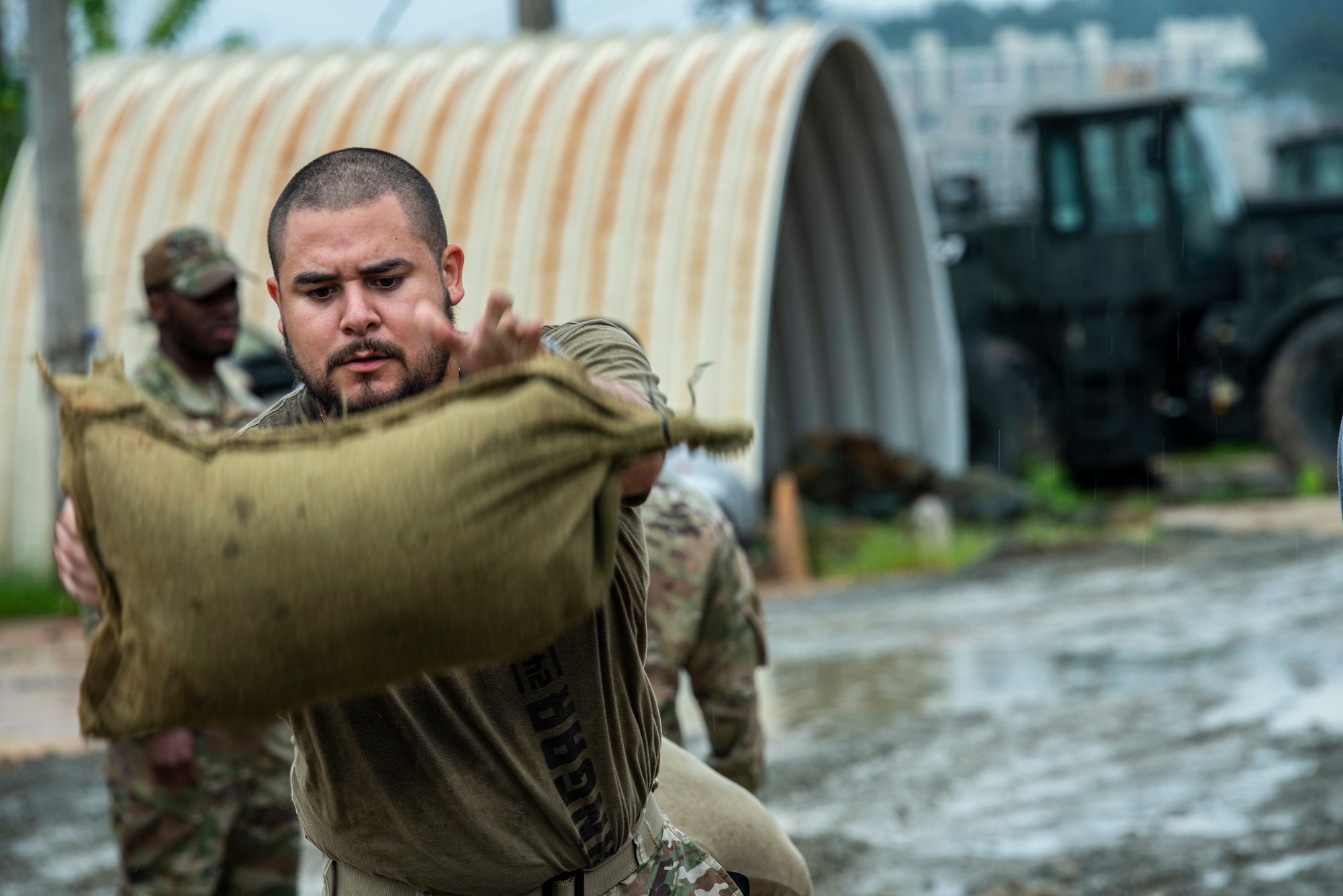 Staff Sgt. Jonathon Vanek, 51st Operations Group aviation resource manager, throws a sandbag at Osan Air Base, Republic of Korea, Aug. 9, 2022.