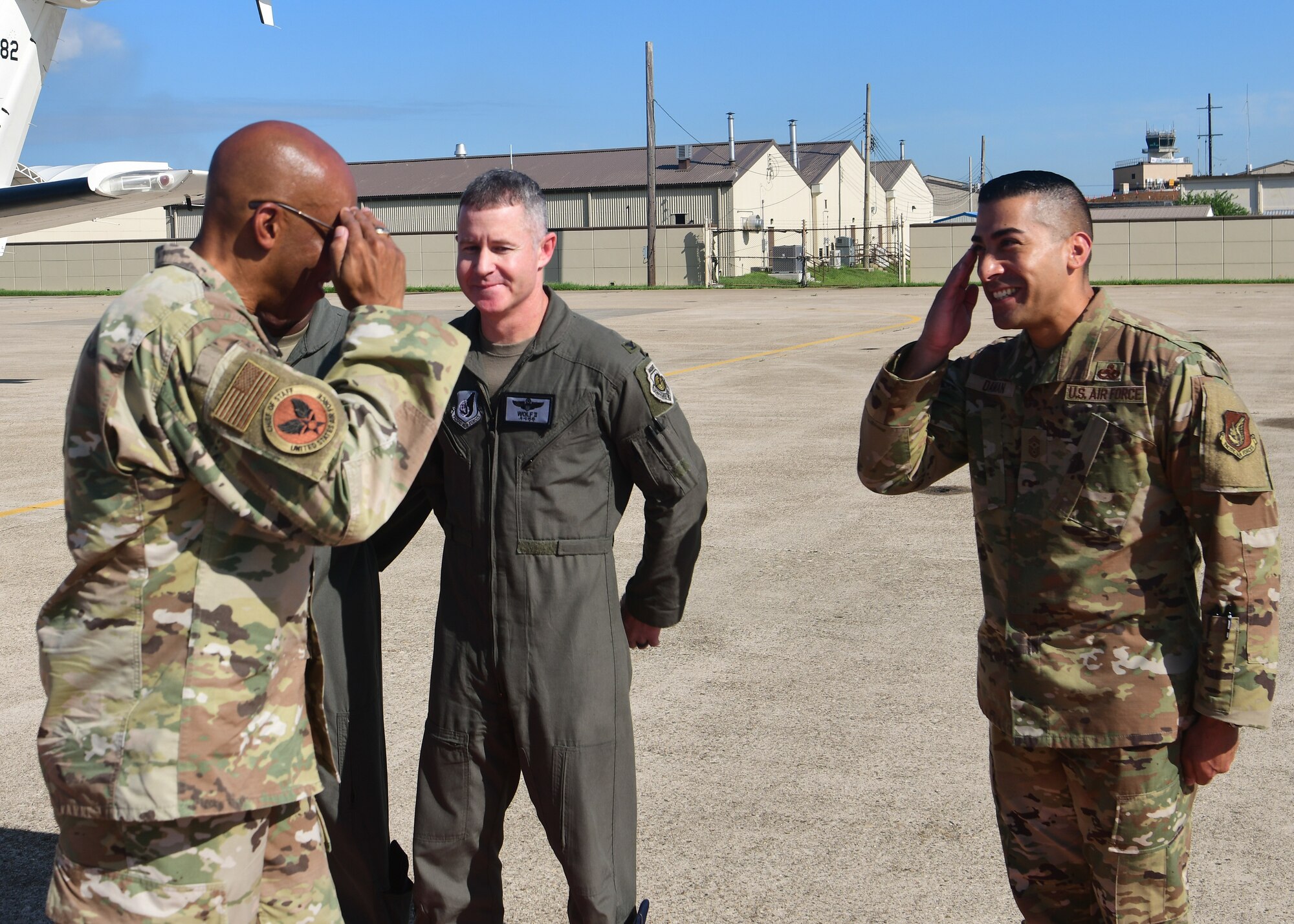 Two military members salute each other.