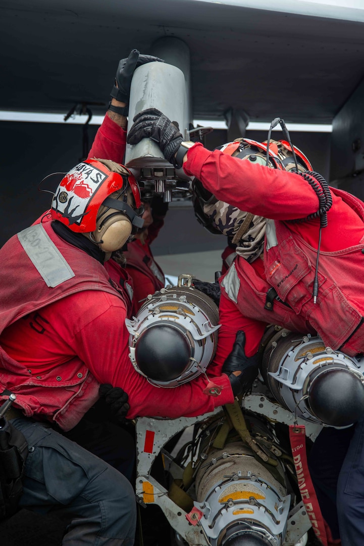 220802-N-DW158-1169 PHILIPPINE SEA (Aug. 2, 2022) Sailors load ordnance onto an F/A-18E Super Hornet attached to the Dambusters of Strike Fighter Squadron (VFA) 195, on the flight deck of the U.S. Navy’s only forward-deployed aircraft carrier USS Ronald Reagan (CVN 76) in the Philippine Sea, Aug. 2. The Dambusters earned their nickname on May 1, 1951 when the squadron's Skyraiders destroyed the heavily defended and strategically positioned Hwacheon Dam in North Korea with aerial torpedoes by making precise low level runs. Ronald Reagan, the flagship of Carrier Strike Group 5, provides a combat-ready force that protects and defends the United States, and supports alliances, partnerships and collective maritime interests in the Indo-Pacific region. (U.S. Navy photo by Mass Communication Specialist 3rd Class Gray Gibson)