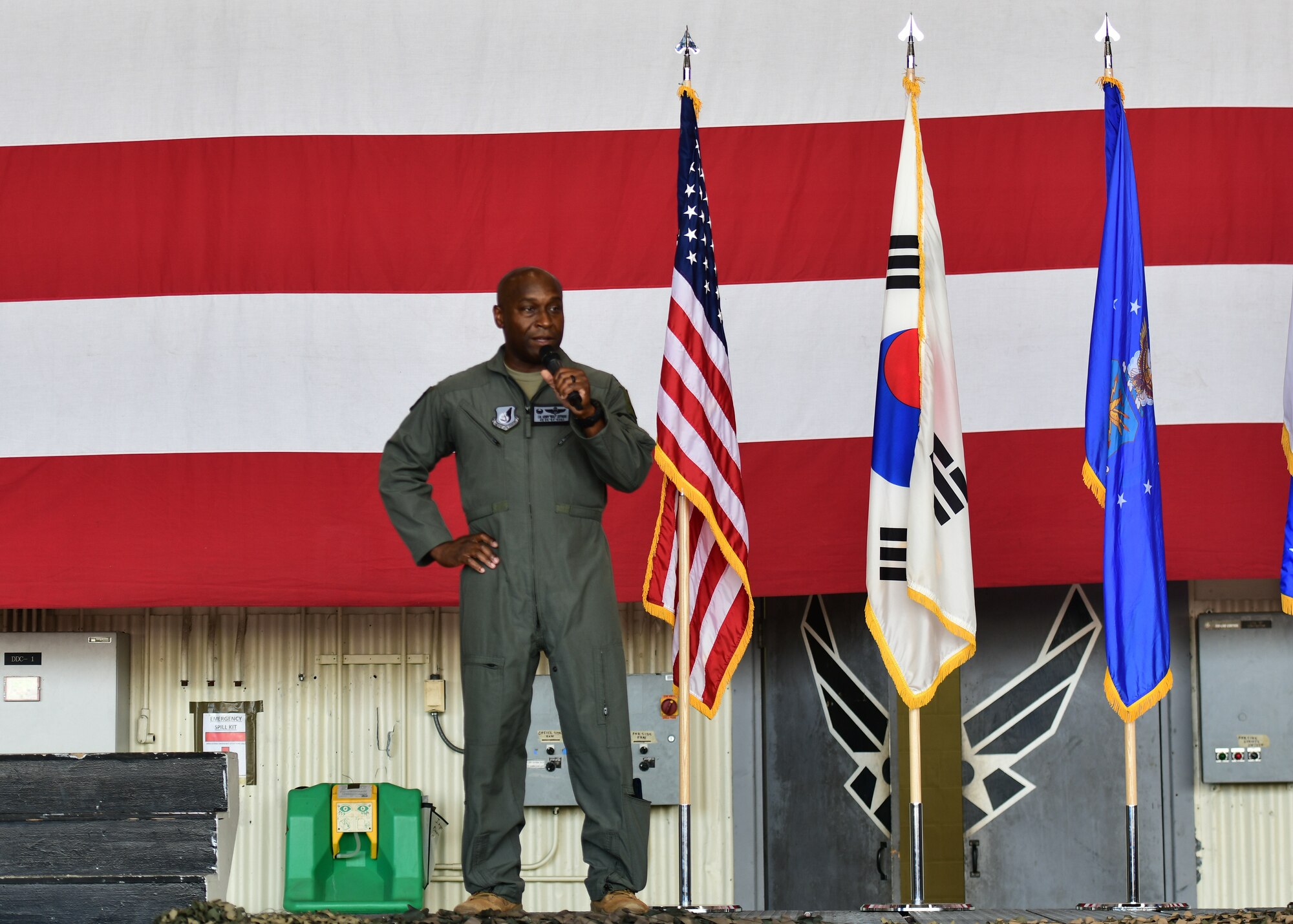 A military member stands on a stage