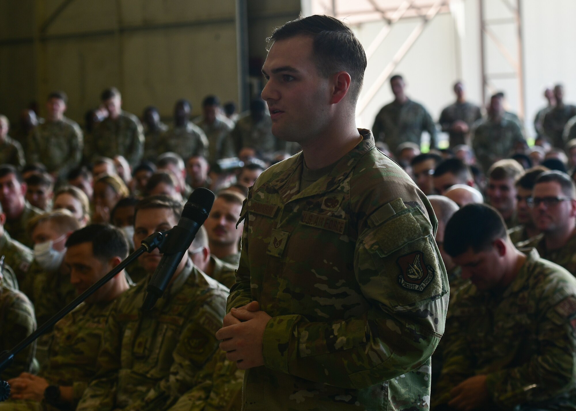 A military member asks a question to the stage.