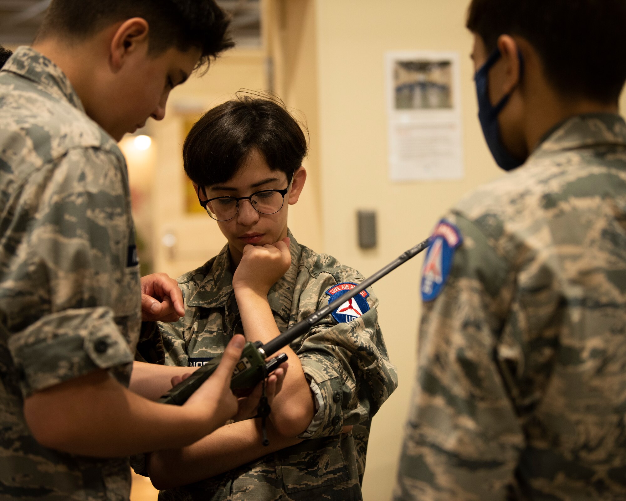 Children in uniform hold a radio