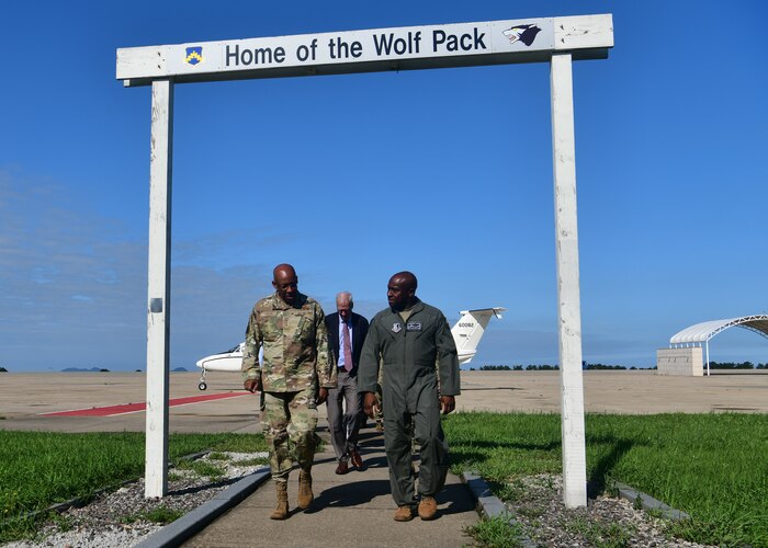 Military members depart a military runway