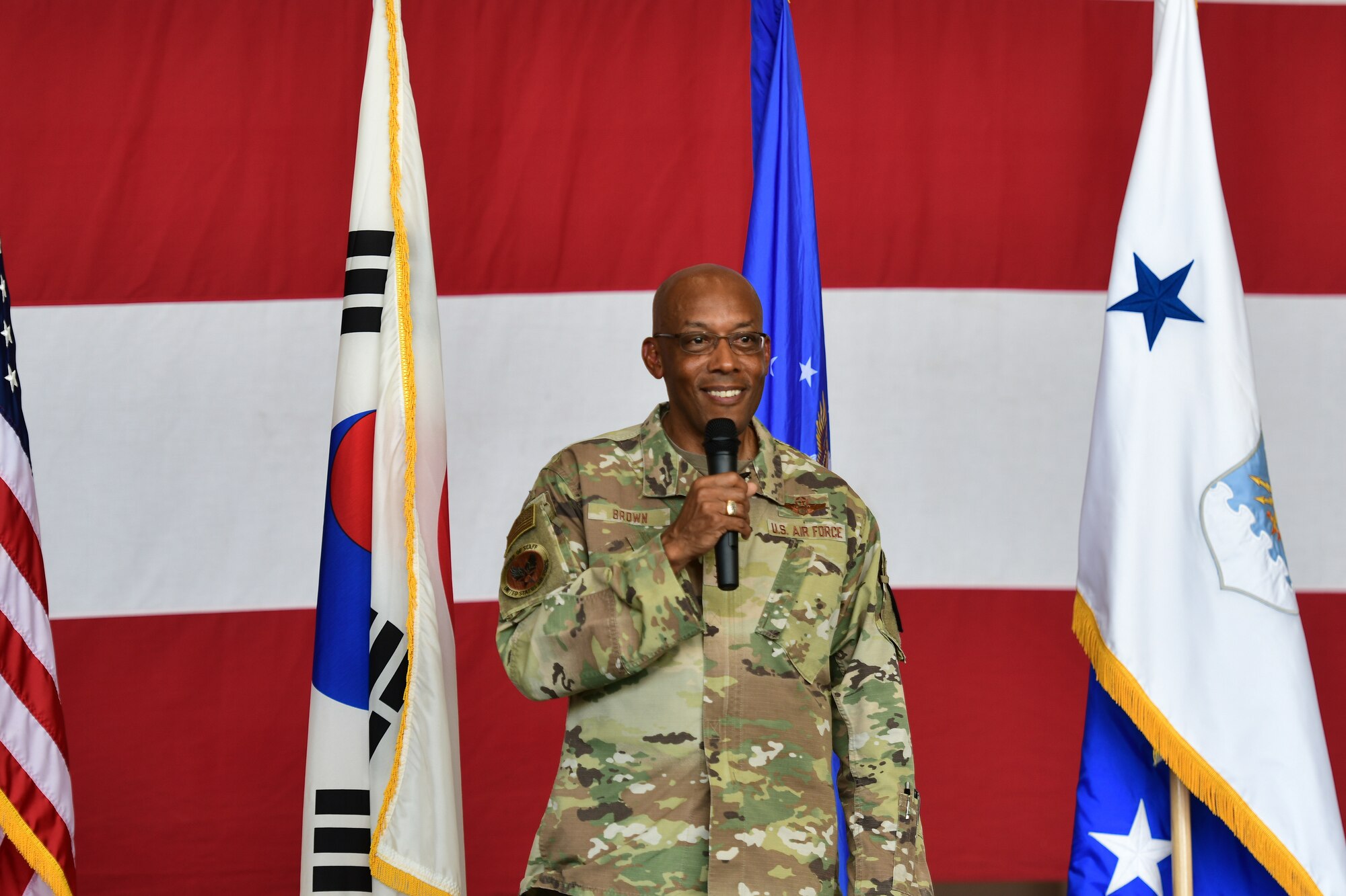 A military member speaks on a stage