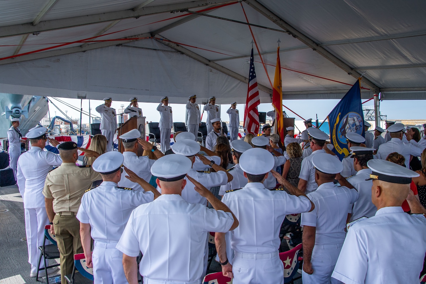Attendees salute the U.S. and Spanish flags at the Commander, Task Force (CTF) 65 change of command ceremony aboard USS Porter (DDG 78) as Capt. Ed Sundberg relieves Capt. Kyle Gantt as Commodore, CTF 65, Aug. 5, 2022.