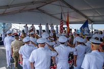 Attendees salute the U.S. and Spanish flags at the Commander, Task Force (CTF) 65 change of command ceremony aboard USS Porter (DDG 78) as Capt. Ed Sundberg relieves Capt. Kyle Gantt as Commodore, CTF 65, Aug. 5, 2022.
