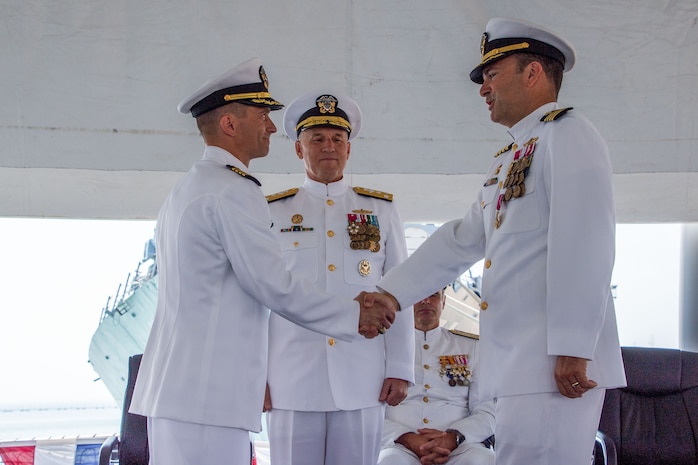 Vice Adm. Gene Black III, commander, U.S. Sixth Fleet, oversees the Commander, Task Force (CTF) 65 change of command ceremony aboard USS Porter (DDG 78) as Capt. Ed Sundberg (left) relieves Capt. Kyle Gantt (right) as Commodore, CTF 65, Aug. 5, 2022.