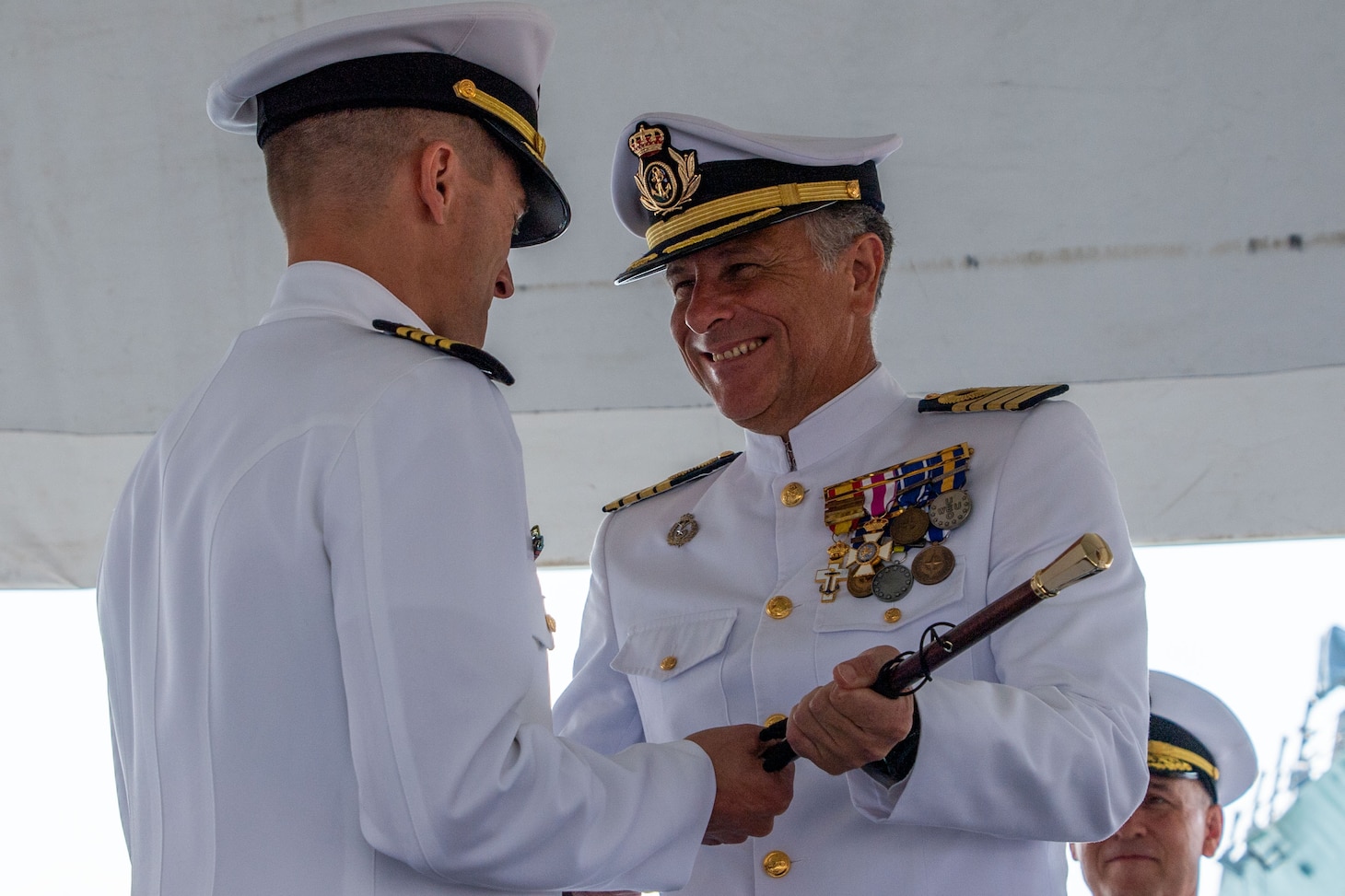 NAVAL STATION ROTA, Spain (Aug. 5, 2022) Attendees salute the U.S. and Spanish flags at the Commander, Task Force (CTF) 65 change of command ceremony aboard USS Porter (DDG 78) as Capt. Ed Sundberg relieves Capt. Kyle Gantt as Commodore, CTF 65, Aug. 5, 2022.