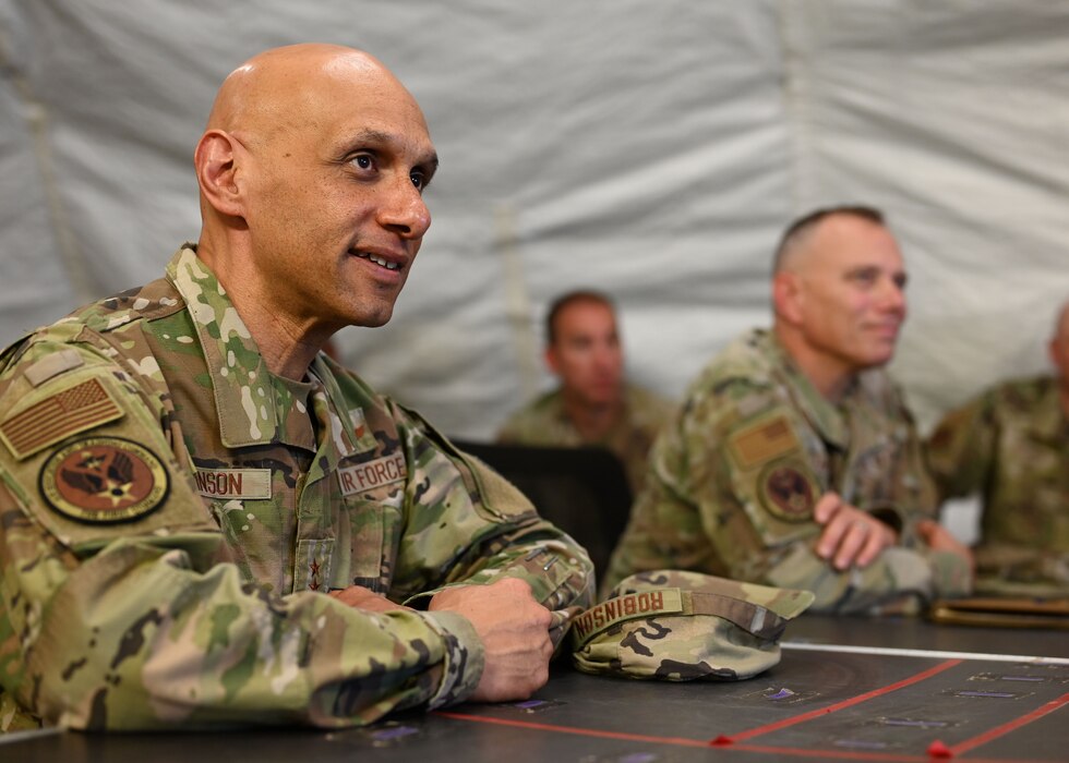 U.S. Air Force Lt. Gen. Brian S. Robinson, commander of Air Education and Training Command, listens to a briefing from a member of the 344th Military Intelligence Battalion during a visit to Forward Operating Base Sentinel, Goodfellow Air Force Base, Texas, Aug. 11, 2022. Robinson was immersed in programs and courses unique to Goodfellow to gain a deeper understanding of the training occurring at the 17th Training Wing. (U.S. Air Force photo by Senior Airman Ethan Sherwood)