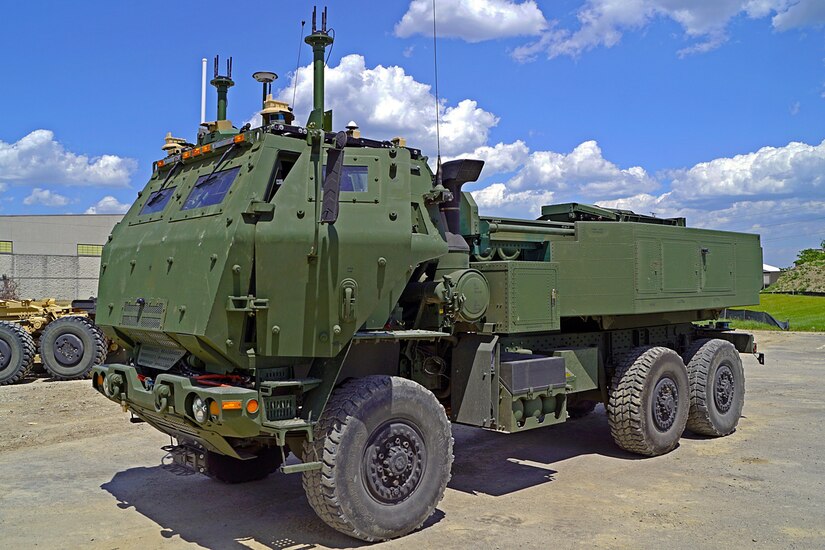 A  military vehicle sits in a parking area.