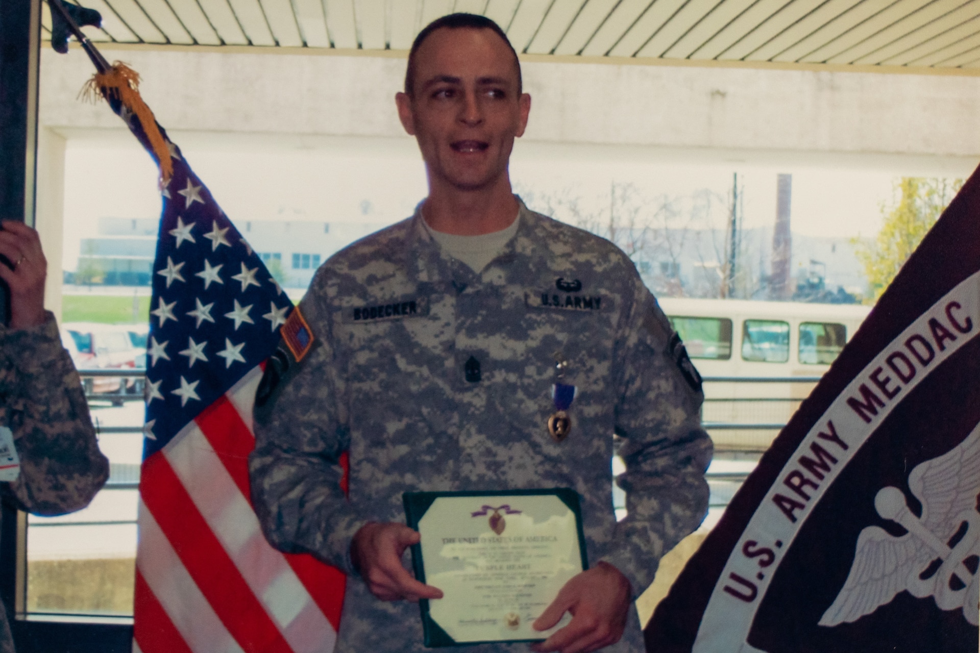 Retired Command Sgt. Maj. James K. Bodecker is awarded the Purple Heart March 20, 2006, at Fort Campbell, Kentucky, after being shot by a sniper in Ramadi, Iraq.