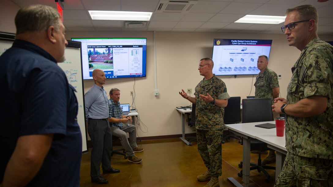 U.S. Marine Corps Brig. Gen. Andrew M. Niebel, left, commanding general, Marine Corps Installations East-Marine Corps Base (MCB) Camp Lejeune speaks with U.S. Marine Corps Maj. Gen. David W. Maxwell, middle, commander, Marine Corps Installations Command, Assistant Deputy Commandant, Installations and Logistics (Facilities), during a scheduled visit on MCB Camp Lejeune, North Carolina, Aug. 4, 2022.