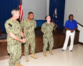 MERIDIAN, Miss. (Aug. 11, 2022) Rear Adm. Pete Garvin, commander, Naval Education and Training Command, left, helps recognize Naval Technical Training Center (NTTC) Meridian staff during an all-hands call at Naval Air Station Meridian, Mississippi, Aug. 11, 2022. NTTC Meridian provides entry-level “A” school training to students in administration and supply ratings, as well as extensive training to top-performing naval personnel in the yeoman rating to qualify as flag writers. (U.S. Navy photo by Penny Randall)
