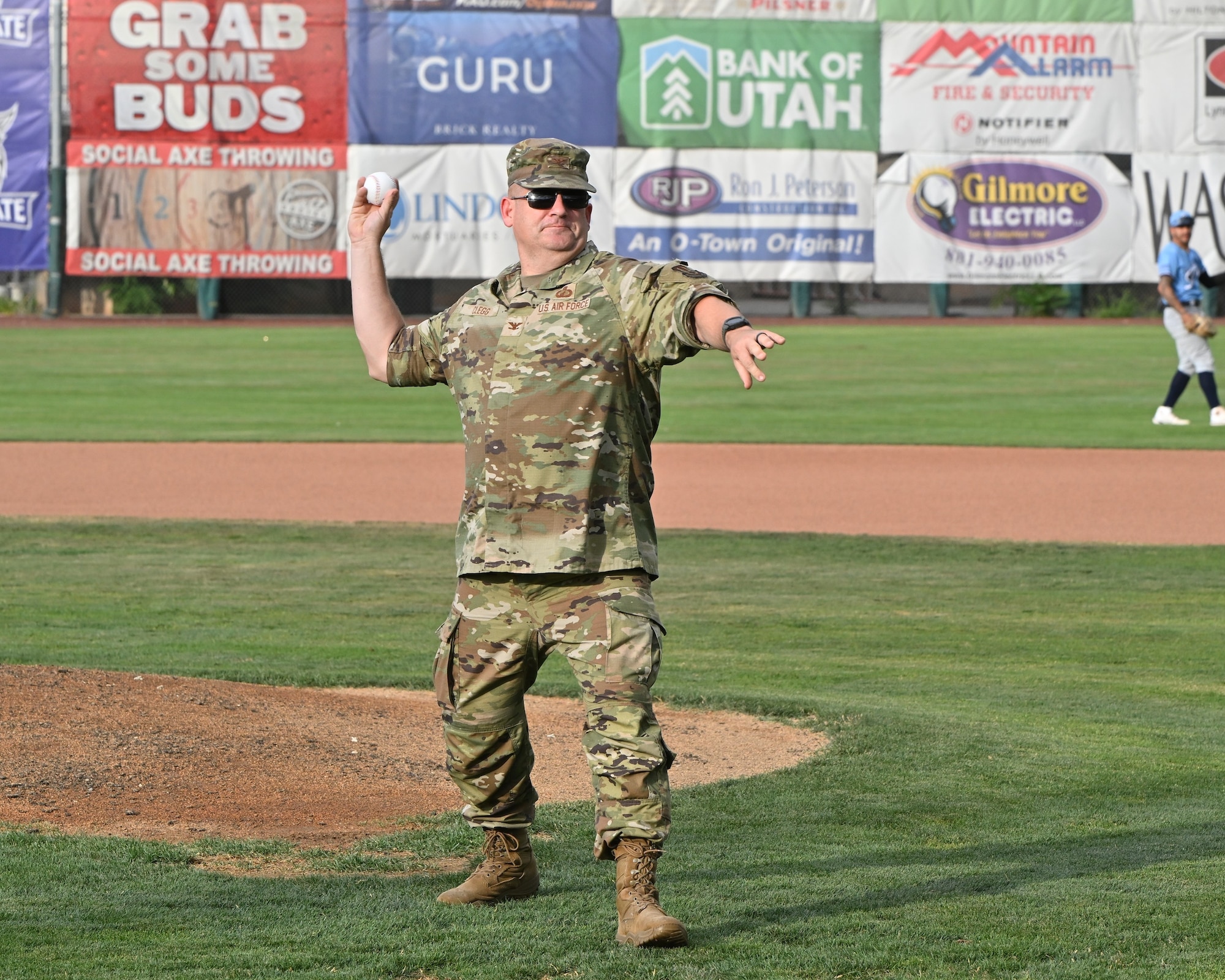 Col. Charles Clegg throws the first pitch in front of the pitcher's mount.