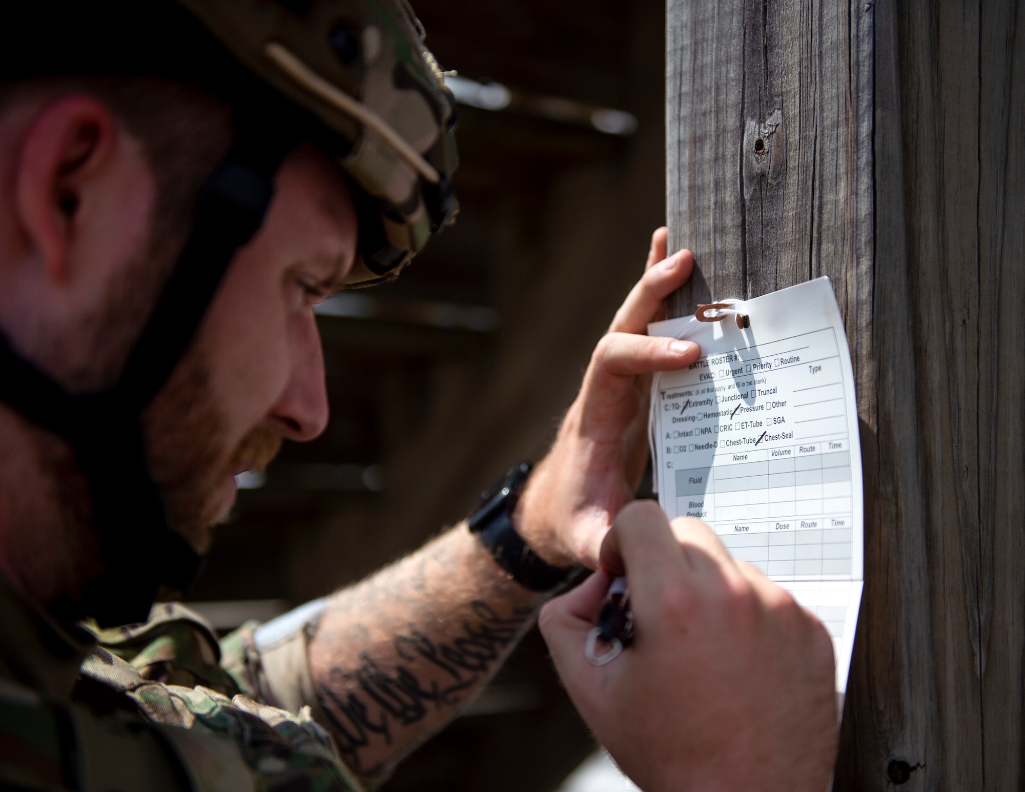 U.S. Air Force Master Sgt. Cody Hallas, 133rd Contingency Response Flight fills out paperwork in Rosemount, Minn., July 27, 2022.