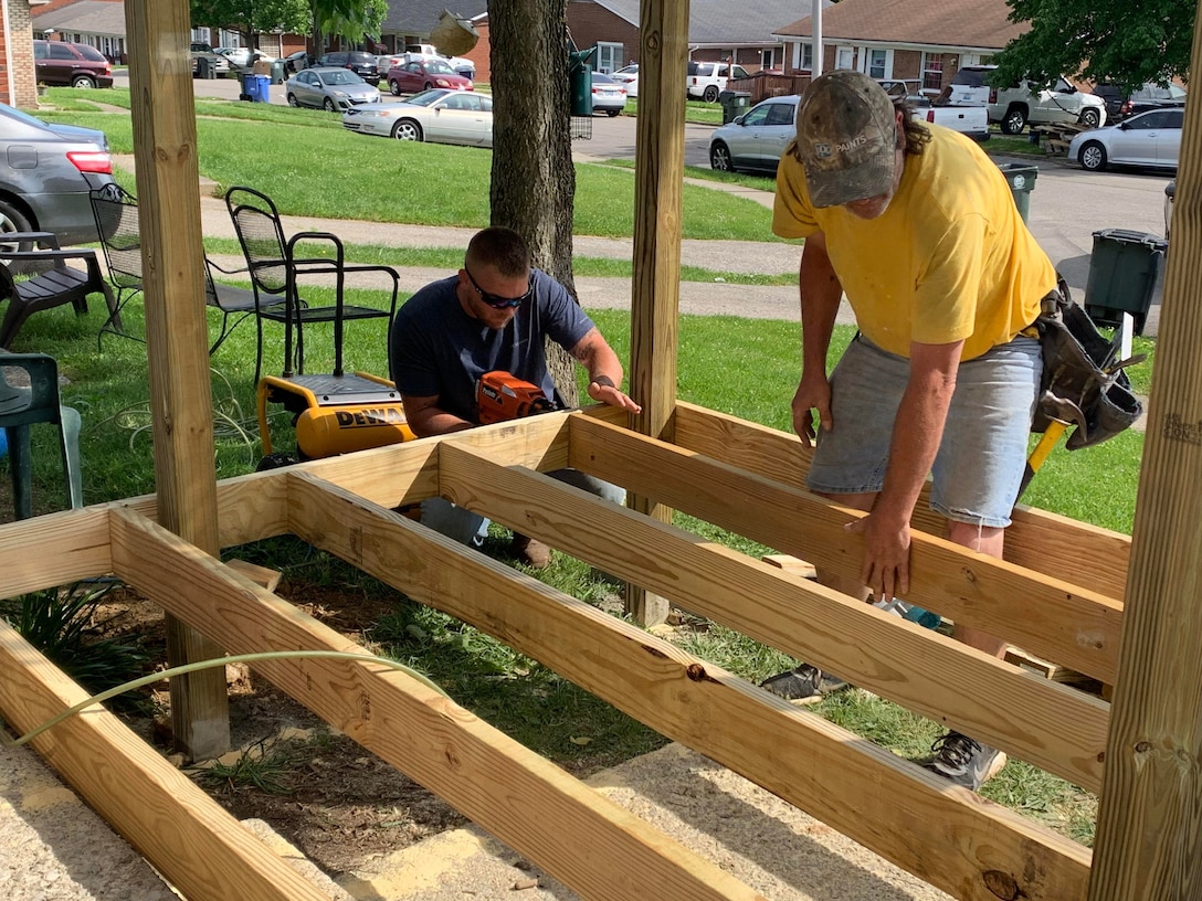 Several Kentucky National Guard Soldiers, as well as, a few civilians, donated their time to help build a needed ramp so Spc. Akir Jackson could access his home with his new electrical wheelchair.