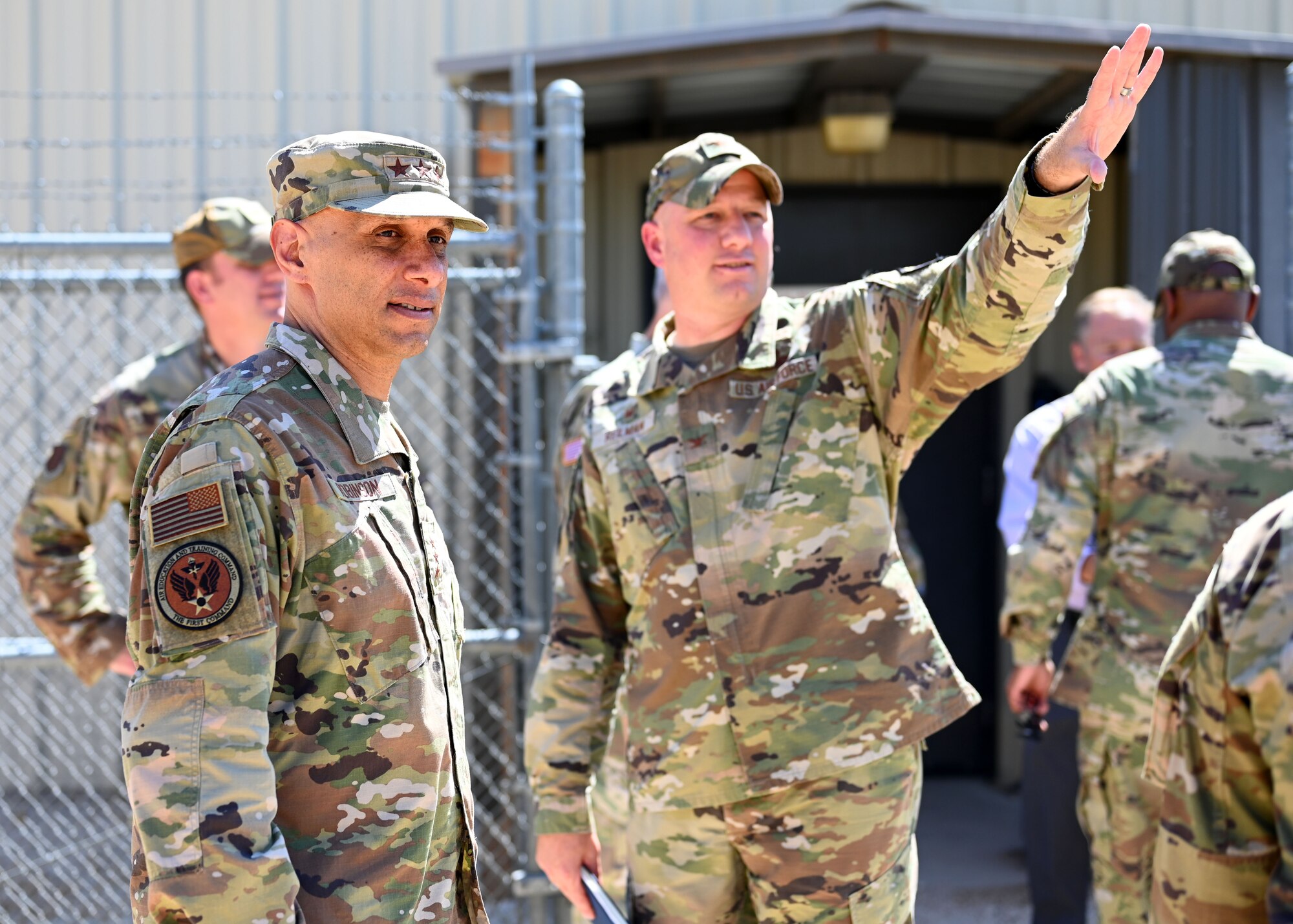 U.S. Air Force Col. Matthew Reilman, 17th Training Wing commander, shows Lt. Gen. Brian S. Robinson, commander of Air Education and Training Command, the simulated deployed area at Forward Operating Base Sentinel, Goodfellow Air Force Base, Texas, Aug. 11, 2022. The area is used for both Army intelligence training and Air Force deployment training. (U.S. Air Force photo by Senior Airman Ethan Sherwood)
