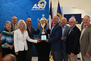 Air Education and Training Command, San Angelo, and Goodfellow leaders take a photo together with the Altus Trophy at the Mayer Museum, San Angelo, Texas, Aug. 11, 2022. Goodfellow and San Angelo lead the Air Force with over 55 agreements benefiting both the base and the local community. (U.S. Air Force photo by Senior Airman Ethan Sherwood)