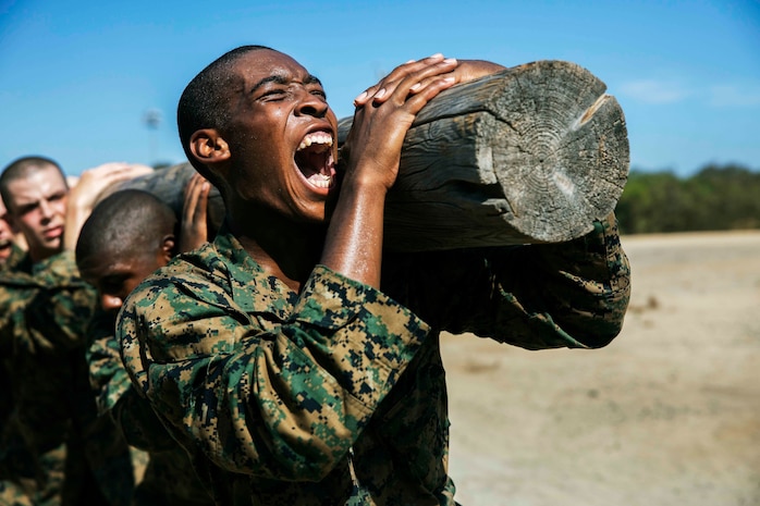 U.S. Marine Corps Recruit Kaleb J. Wilson with Fox Company, 2nd Recruit Training Battalion, executes squats during log drills at Marine Corps Recruit Depot San Diego, Aug. 8, 2022.