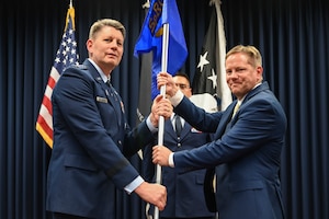 Men hold flag.