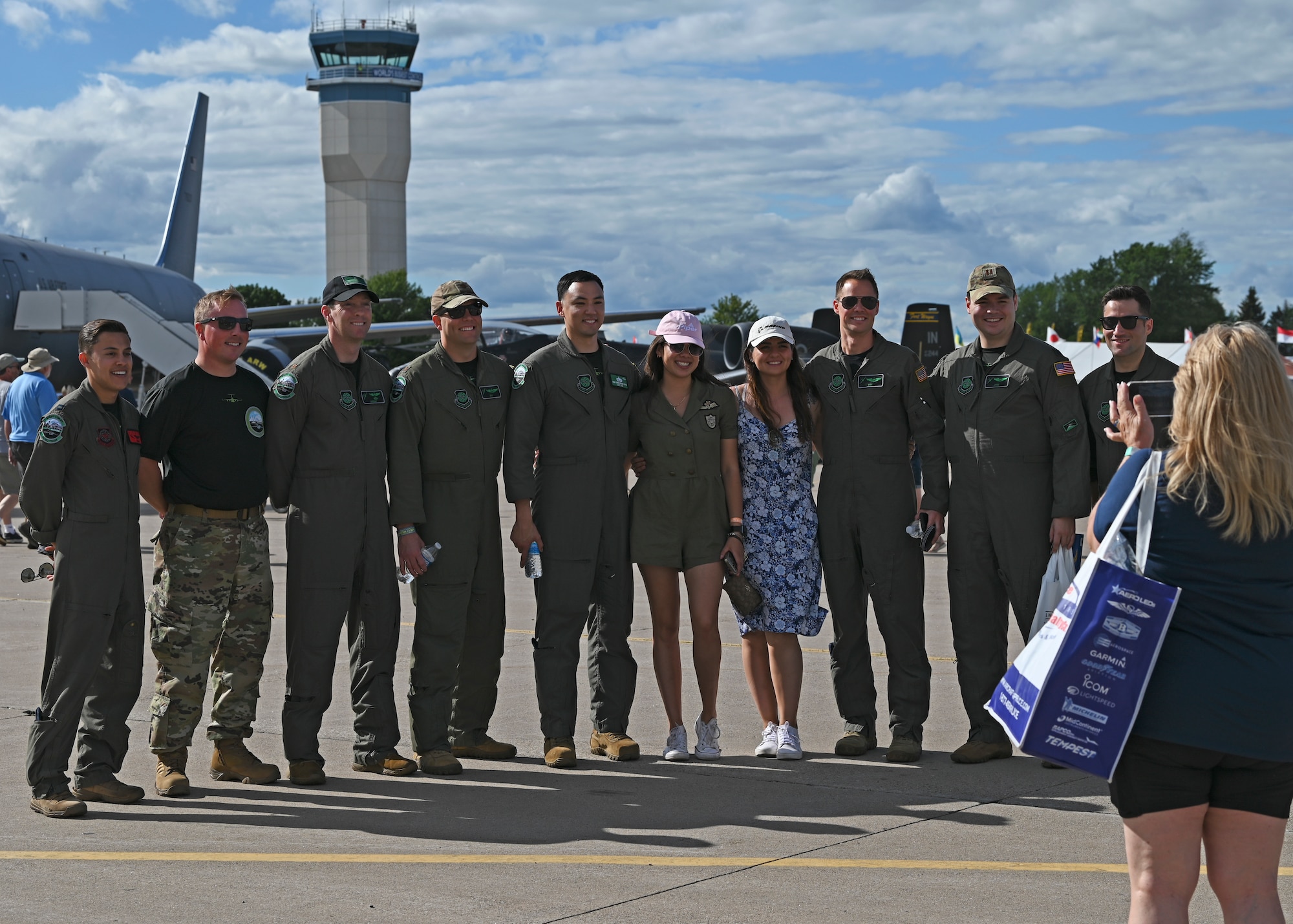 U.S. Air Force C-17 West Coast Demonstration Team, assigned to the 62d Airlift Wing, poses for a photo with spectators at the Experimental Aircraft Association Airventure Air Show, Oshkosh, Wis., July 29, 2022. EAA is the largest annual air show in the U.S. and coined as The World’s Greatest Aviation celebration. (U.S. Air Force photo by Senior Callie Norton)