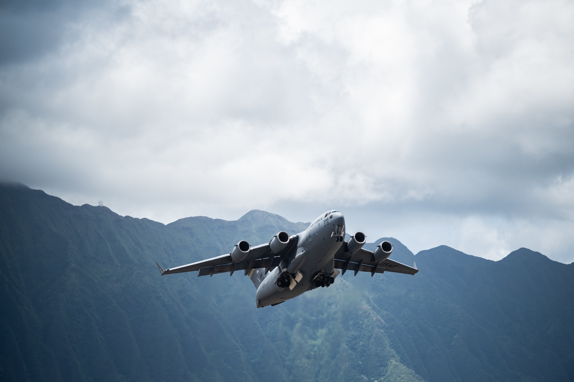 A C-17 Globemaster III assigned to the 535th Airlift Squadron takes off during the Kaneohe Bay Air Show at Marine Corps Base Hawaii, Hawaii, Aug. 12, 2022. The C-17 is capable of rapid strategic delivery of troops and cargo to main operating bases or to forwarding bases in deployment areas. (U.S. Air Force by Staff Sgt. Alan Ricker)
