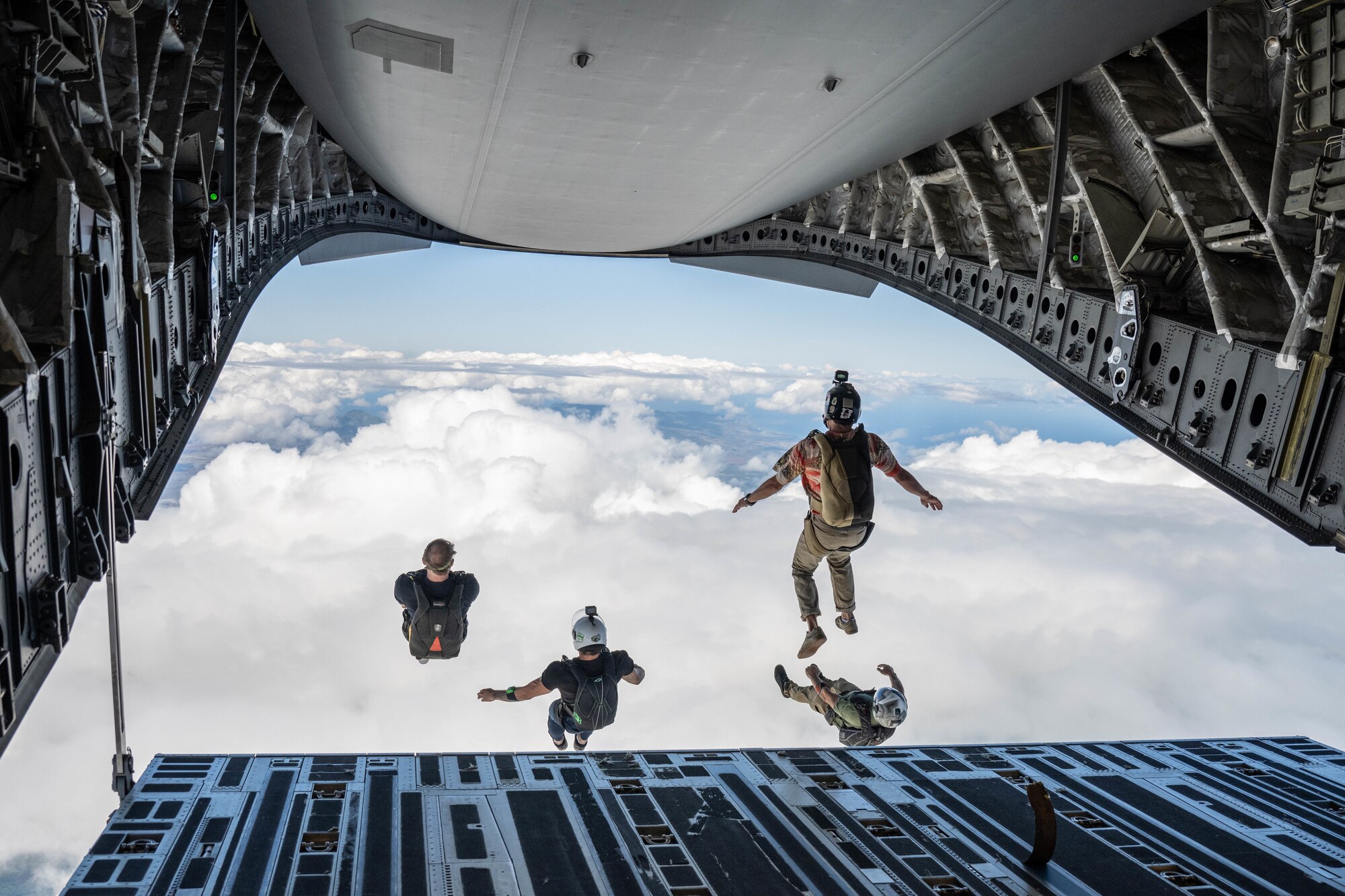 Members from the Flying Leathernecks Demonstration Skydiving team exit a C-17 Globemaster III during the Kaneohe Bay Air Show at Marine Corps Base Hawaii, Hawaii, Aug. 13, 2022. The airshow kicked off with an aerial performance by 16 members of the team. (U.S. Air Force photo by Senior Airman Makensie Cooper)