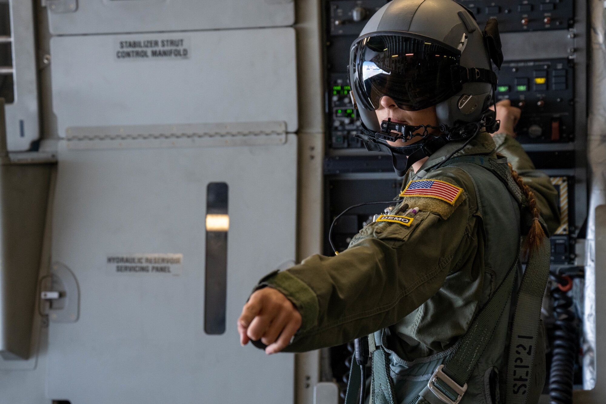 Senior Airman Jolan Besse, 535th Airlift Squadron loadmaster, operates the ramp of a C-17 Globemaster III during an airdrop for the Kaneohe Bay Air Show at Marine Corps Base Hawaii, Hawaii, Aug. 13, 2022. The air show featured static displays, aerial performances and aircraft demonstrations to show appreciation for the support given by the local community. (U.S. Air Force photo by Senior Airman Makensie Cooper)