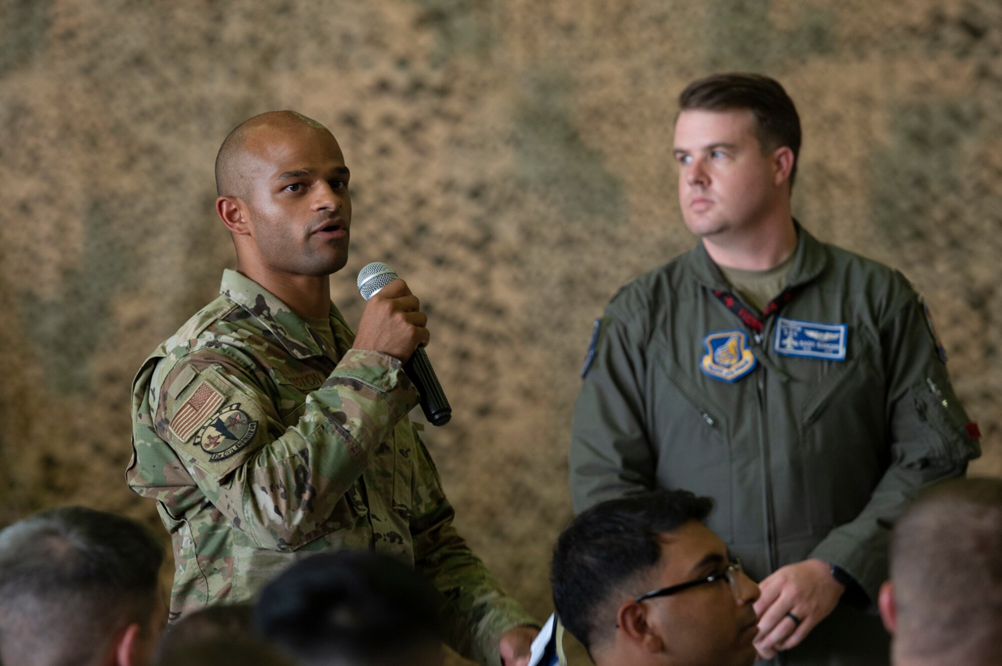 An Airman assigned to the 51st Fighter Wing asks Air Force Chief of Staff Gen. CQ Brown, Jr., a question during the Q&A portion of an all-call at Osan Air Base, Republic of Korea, Aug. 12, 2022.