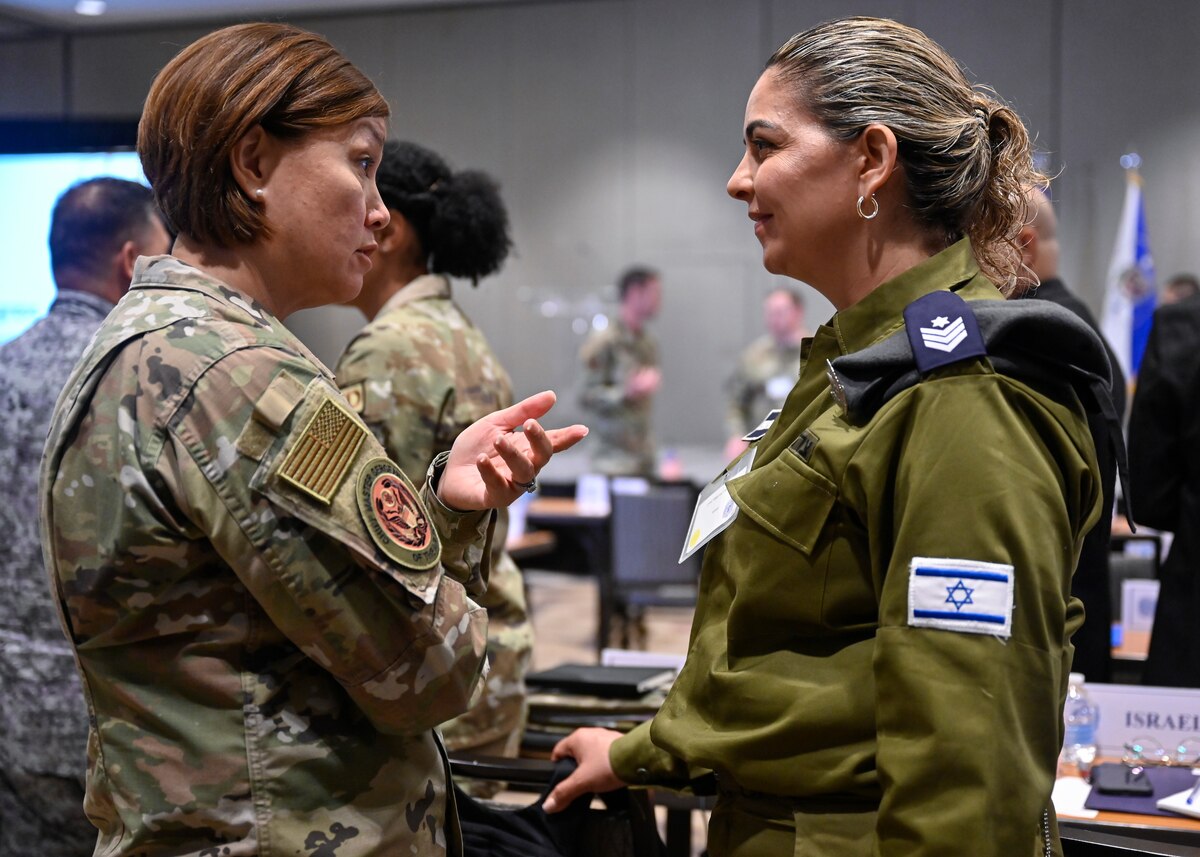 Chief Master Sgt. of the Air Force JoAnne S. Bass speaks with an Israeli Air Force attendee during the Senior Enlisted Leader International Summit in Arlington, Va., Aug. 1, 2022. The summit hosted senior enlisted leaders from 54 countries to reinforce partnerships between military services. (U.S. Air Force photo by Eric Dietrich)