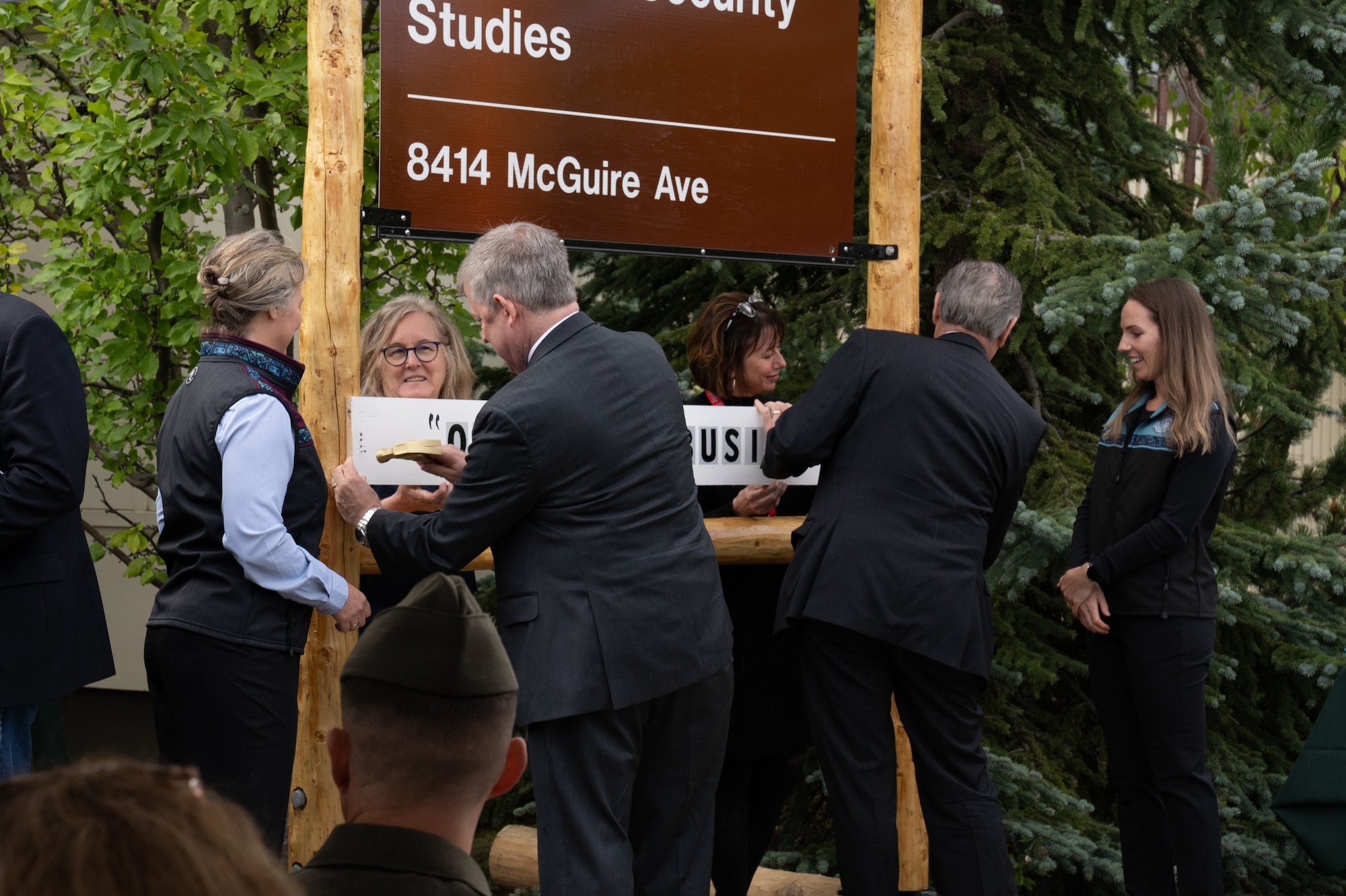 A photo of a group putting up a sign