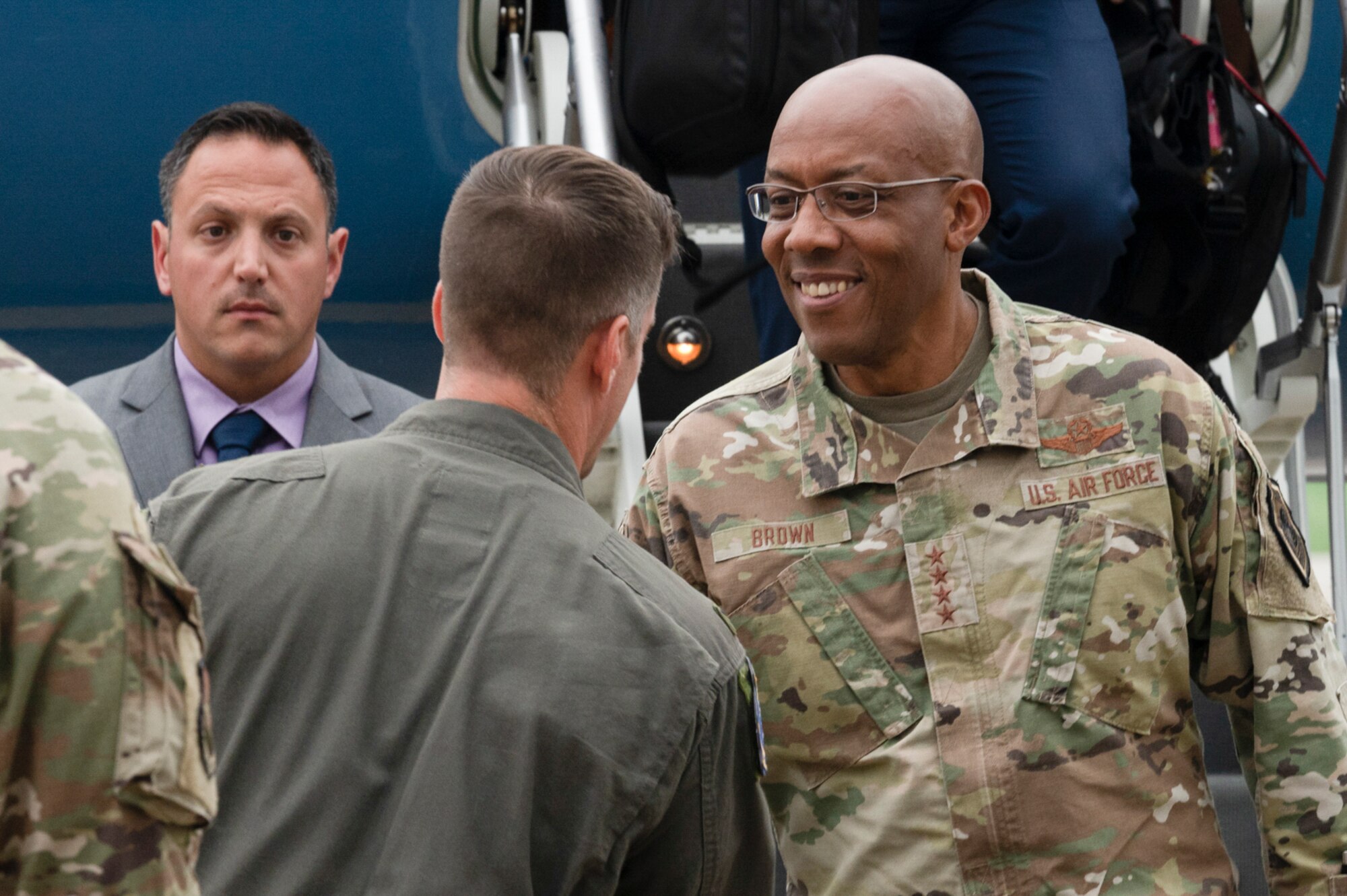 Air Force Chief of Staff Gen. CQ Brown, Jr. shakes hands with 51st Fighter Wing Commander, Col. Joshua Wood, at Osan Air Base, Republic of Korea, Aug. 12, 2022.