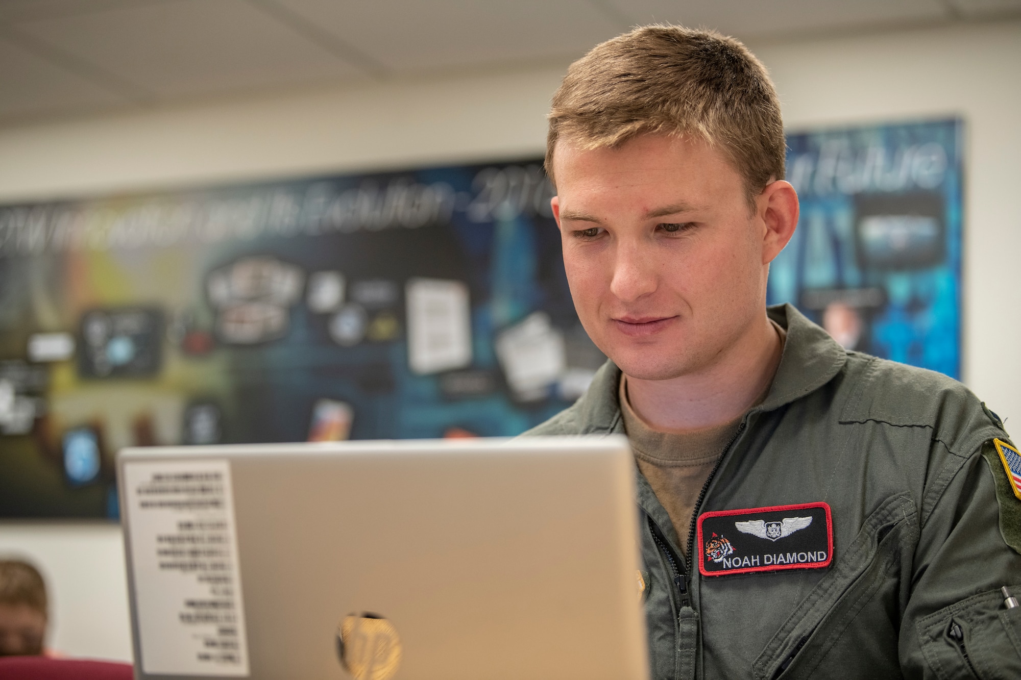 Military member works on computer.