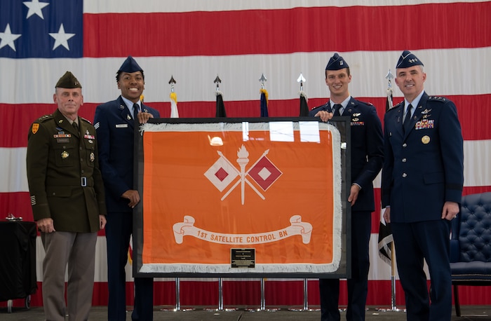 U.S. Army Lt. Gen. Daniel Karbler (left), commander of the U.S. Army Space and Missile Defense Command, presents the 53rd Signal Battalion colors to U.S. Space Force Lt. Gen. Stephen Whiting (right), commander of Space Operations Command, during a ceremony at Peterson Space Force Base, Colorado, Aug. 15, 2022. The passing of the colors signifies the U.S. Army
satellite communications mission transferring to the U.S. Space Force, consolidating all Department of Defense SATCOM functions under one service for the first time. (U.S. Space Force photo by Airman 1st Class Aliviah Williams)