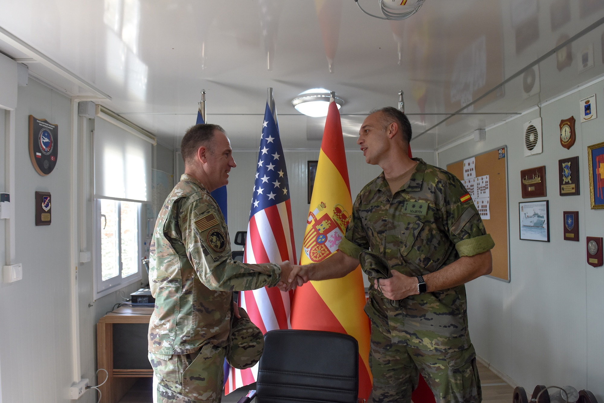 U.S. Brig. Gen. Patrick Ryder (left), Office of the Secretary of the Air Force director of public affairs, and Spanish Army Lt. Col. Sergio Martín Gallego, Spanish Patriot Unit commander, exchange coins at the Spanish Battery Compound during a visit on Incirlik Air Base, Turkey, Aug. 4, 2022.