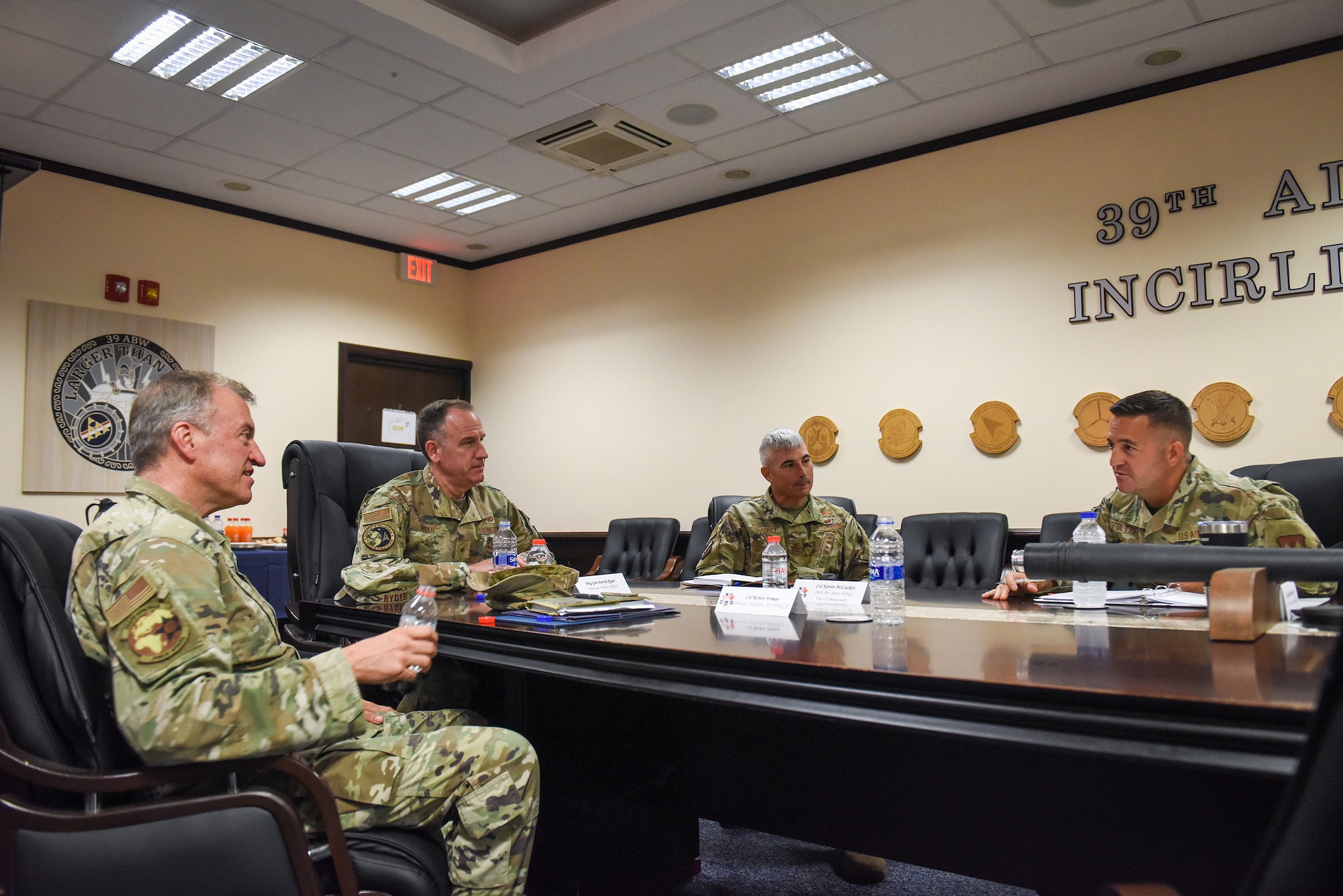 Col. Robert Firman (left), U.S. Air Forces in Europe-Air Forces Africa director of public affairs, and Brig. Gen. Patrick Ryder (left center), Office of the Secretary of the Air Force director of PA, meet with Col. Kevin McCaskey (right center), 39th Air Base Wing vice commander, and Chief Master Sgt. Justin Stoltzus, 39th ABW command chief, during a visit on Incirlik Air Base, Turkey, Aug. 4, 2022.