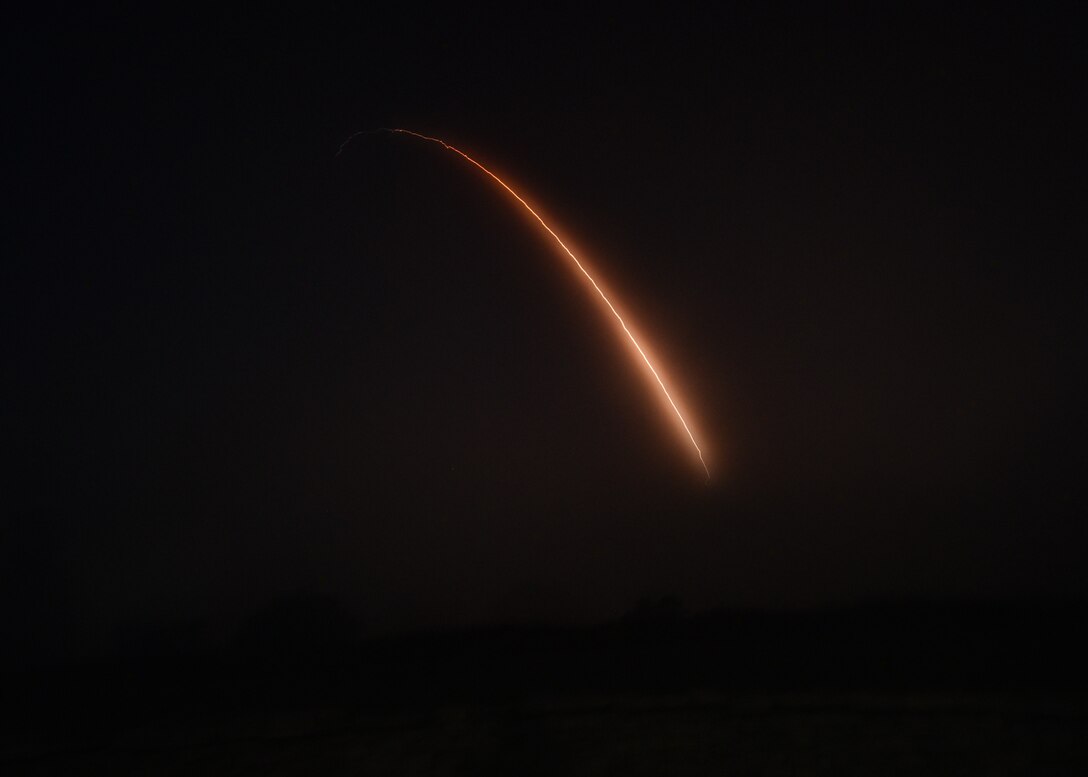 missile streaking through the sky at night