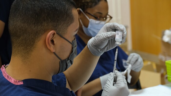NMRTC Yokosuka Sailors prepare COVID-19 vaccines for base wide Shotex events to allow medical staff to vaccinate a larger population in a short amount of time.