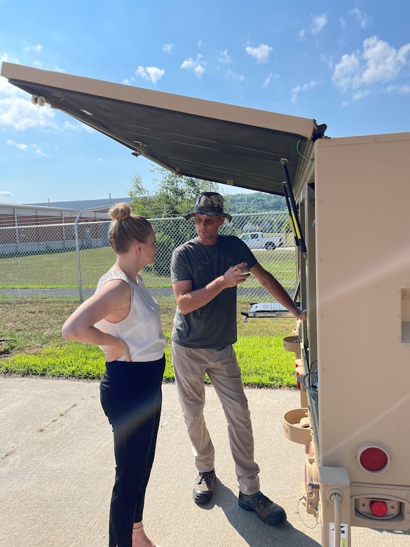 Photo of Adam Merriman discussing STT functionalities with Nicole Ford.