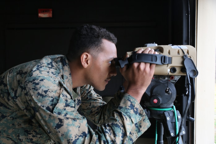 Lance Corp. Dwight Amos peers through a prototype version of the Next-Generation Handheld Targeting System, March 2021 at U.S. Army Garrison Fort A.P. Hill, Virginia.