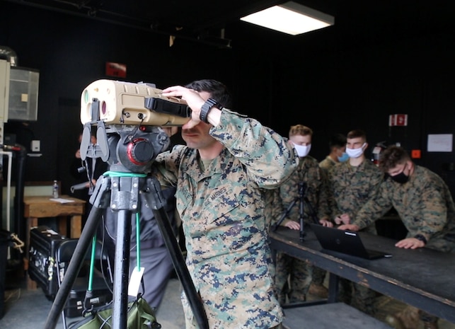 Marine peers through a prototype version of the Next-Generation Handheld Targeting System, March 2021 at U.S. Army Garrison Fort A.P. Hill, Virginia.