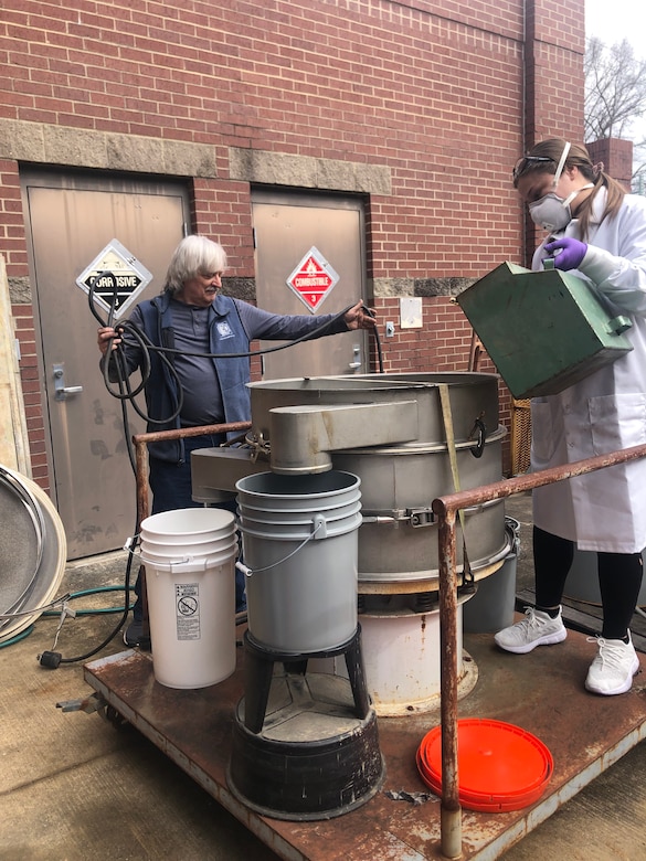 Dr. Paul Schroeder (right), and Jesseca Alexander (left) are preparing to use a large shaker sieve