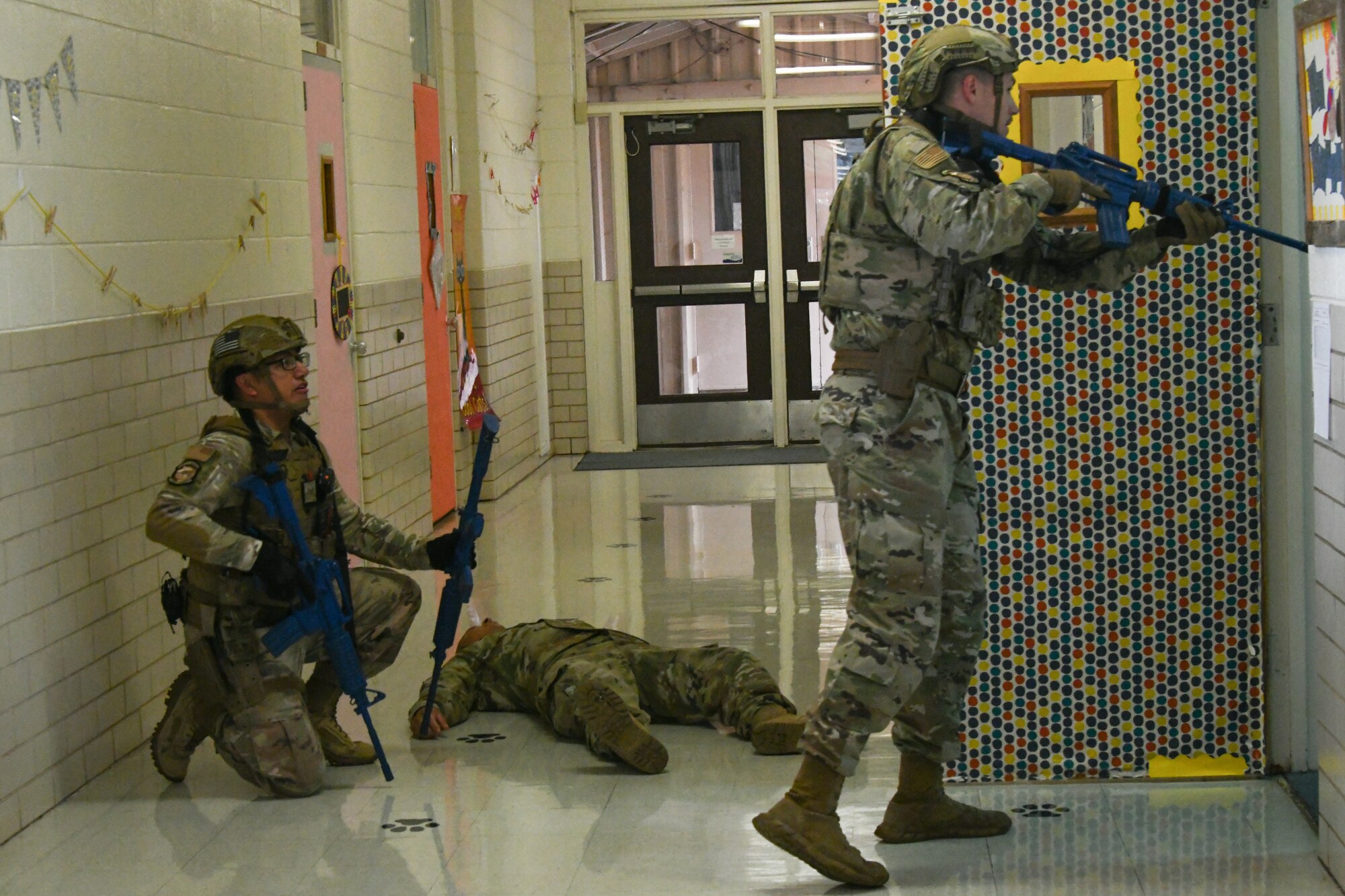 Staff Sgt. Andrew Luna and Staff Sgt. Dakota Reinsch, 97th Security Forces Squadron patrolmen, clear a room during an active shooter exercise at Altus Air Force Base, Oklahoma, Aug. 10, 2022. Exercises like this are held to test preparedness and response to a high threat situation. (U.S. Air Force photo by Airman 1st Class Miyah Gray)