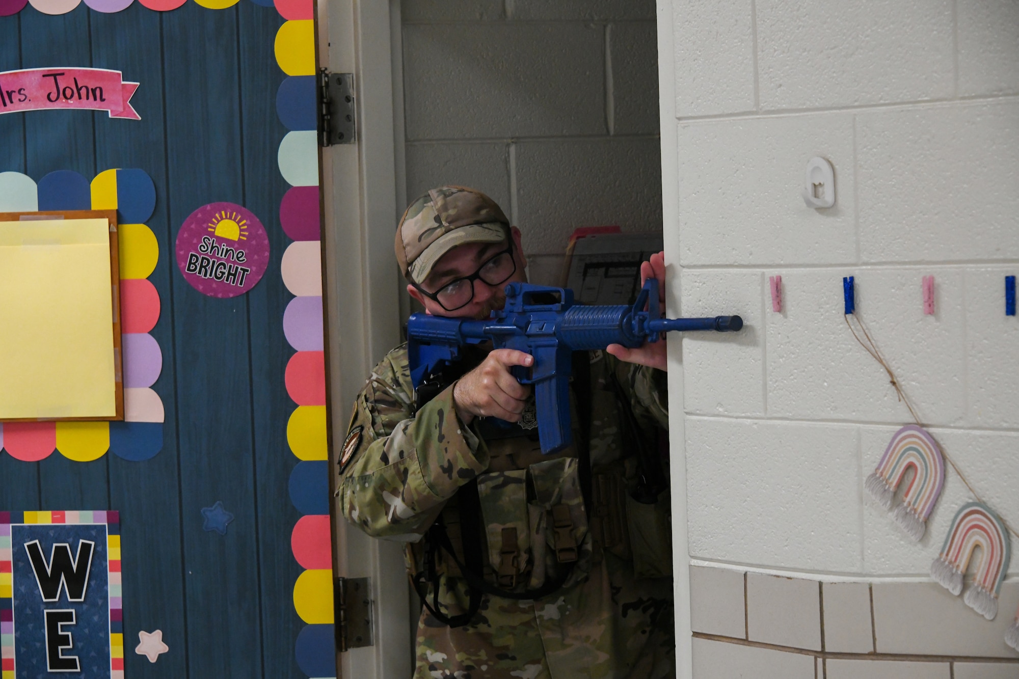 U.S. Air Force Senior Airman Jeffery Warwick, 97th Security Forces Squadron patrolman, guards a door during an active shooter training exercise at Altus Air Force Base, Oklahoma, Aug. 8, 2022. The exercise was a base-wide effort, including active participants from various groups and squadrons. (U.S. Air Force photo by Airman 1st Class Miyah Gray)